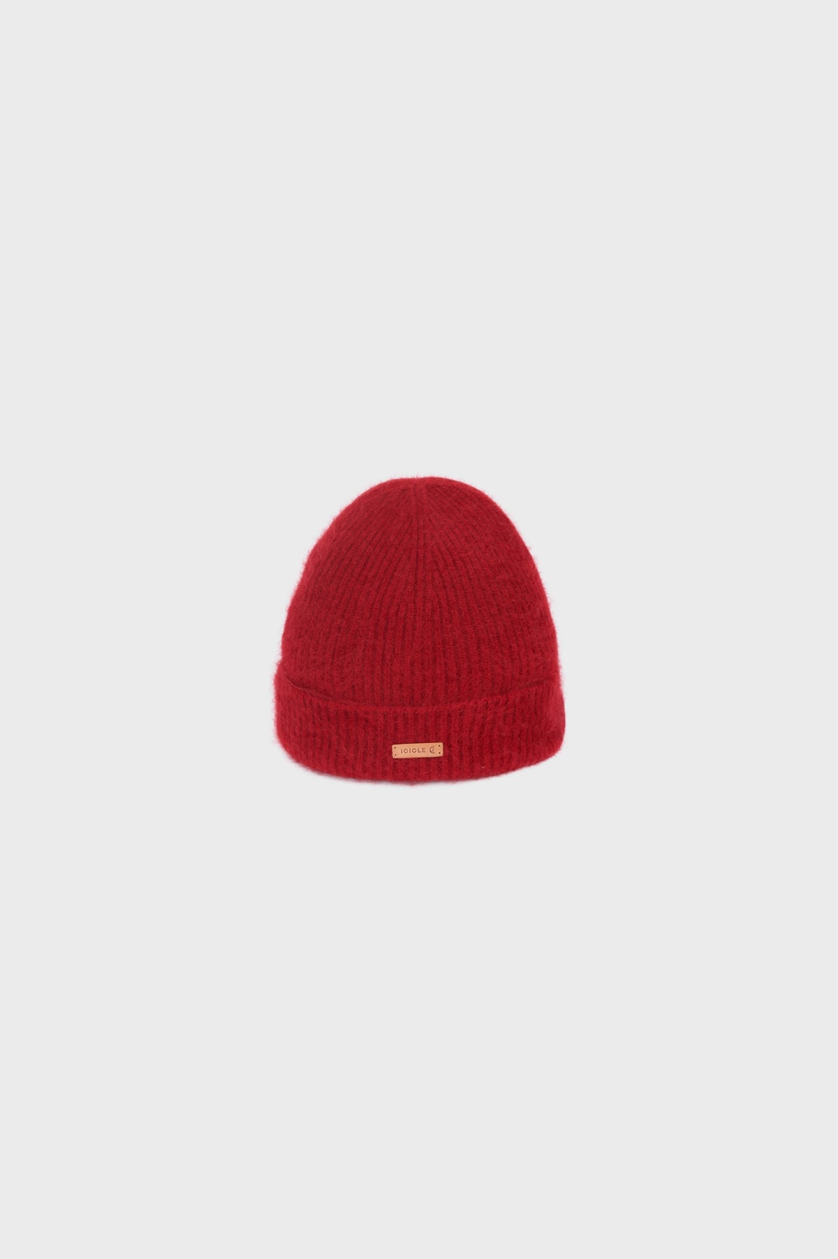 Studio shot of the red cashmere beanie, showing its rounded silhouette and ribbed knit texture.