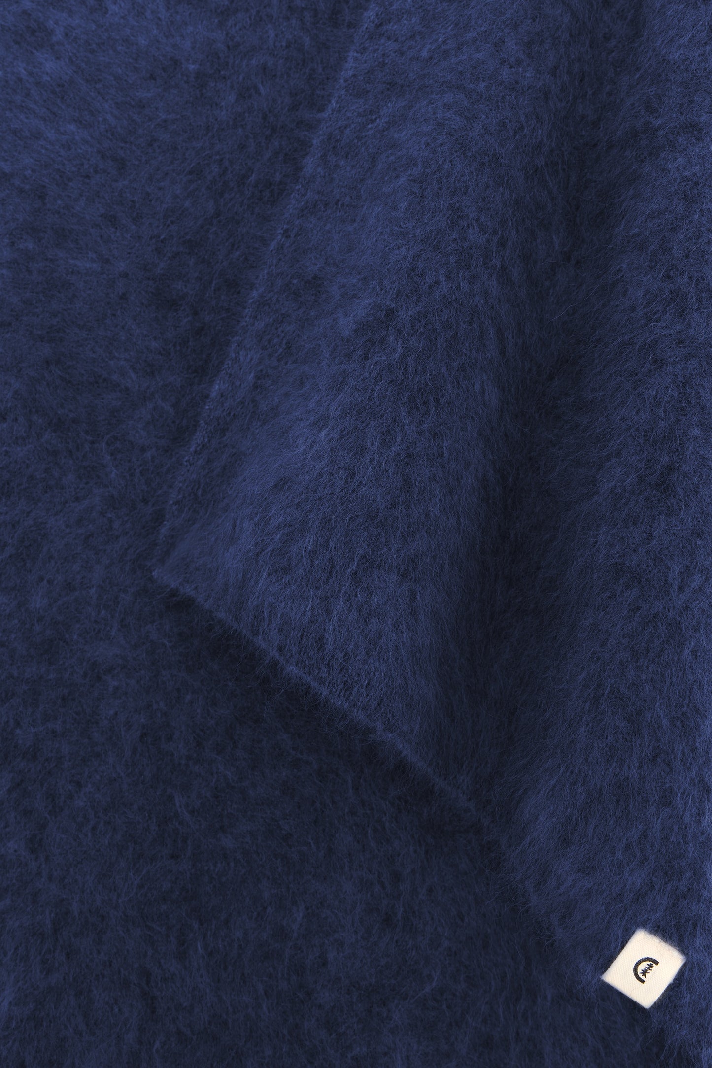 Close-up showing the fine weave and soft, plush surface of the cashmere material.
