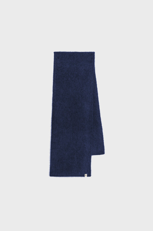 Flat-lay view of the navy blue cashmere scarf showing its long rectangular shape and clean edges.