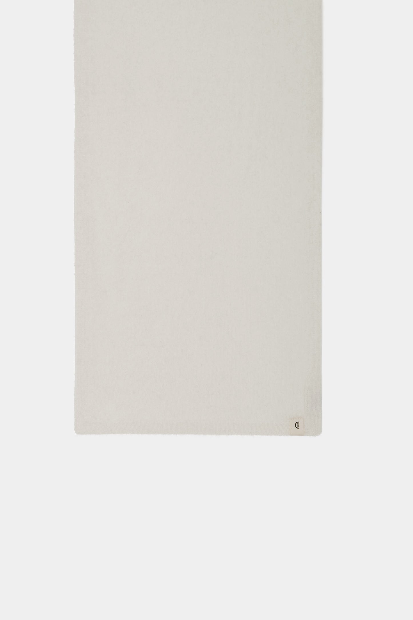 Folded close-up showing the light, smooth texture and soft sheen of the cashmere fabric.