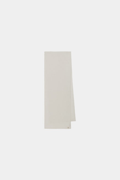 Flat-lay view of the ivory cashmere scarf, highlighting its refined tone and minimalist shape.