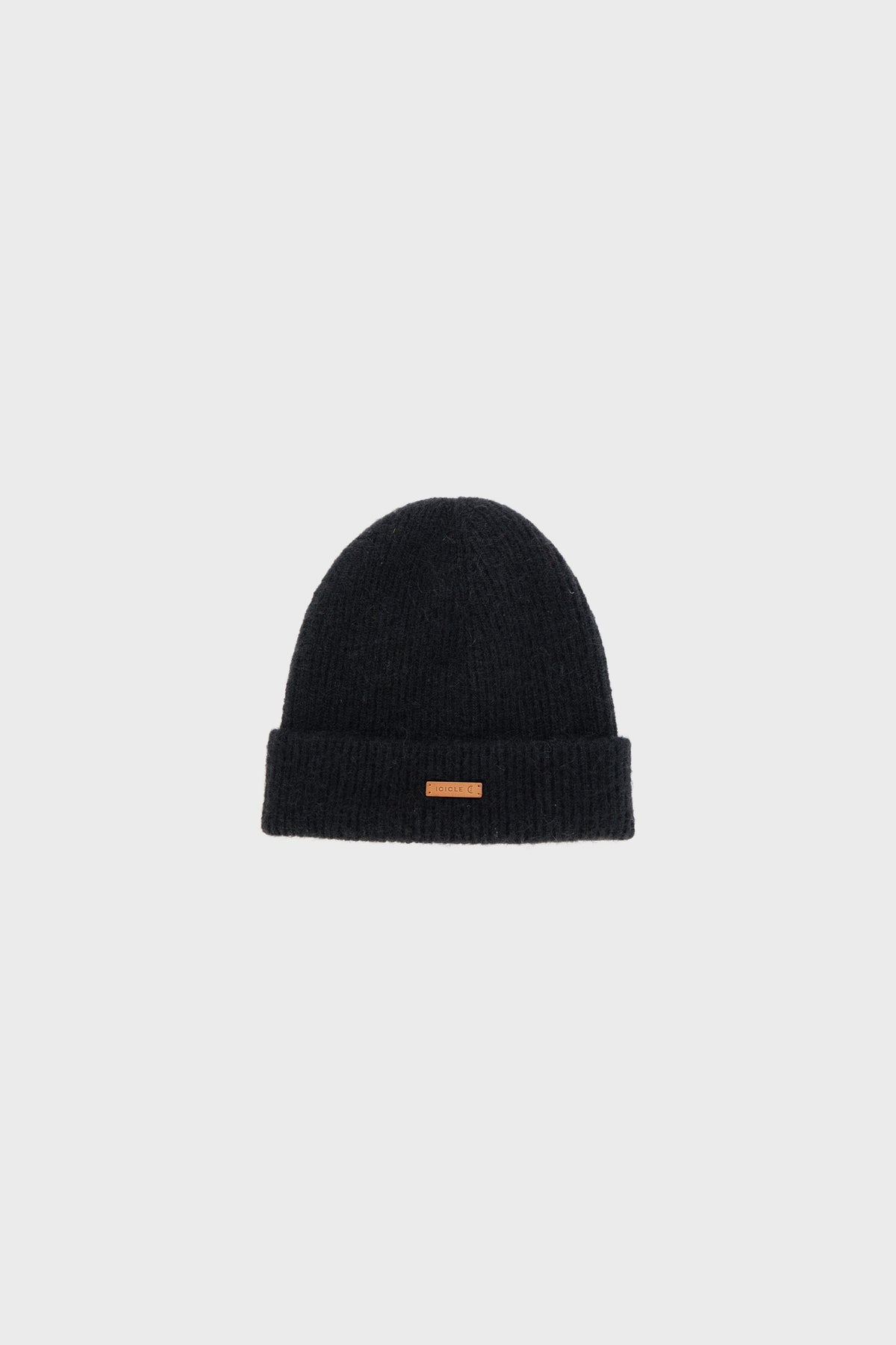 Flat product view presenting the overall shape and proportions of the beanie. The image highlights the rounded crown, folded brim and compact silhouette, emphasizing the simple construction and timeless character of the accessory.