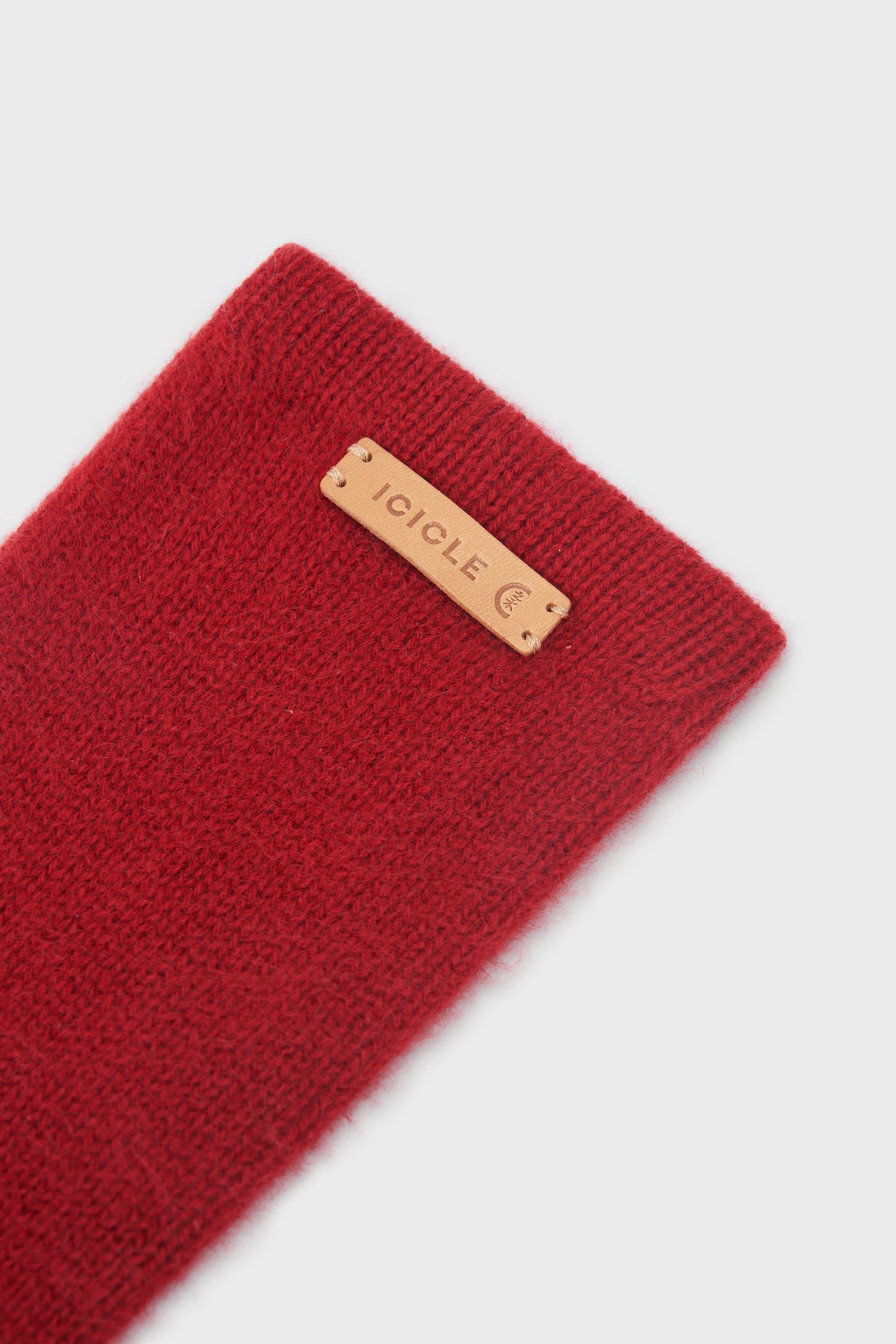 Close-up of the ICICLE logo patch and soft, brushed cashmere texture.