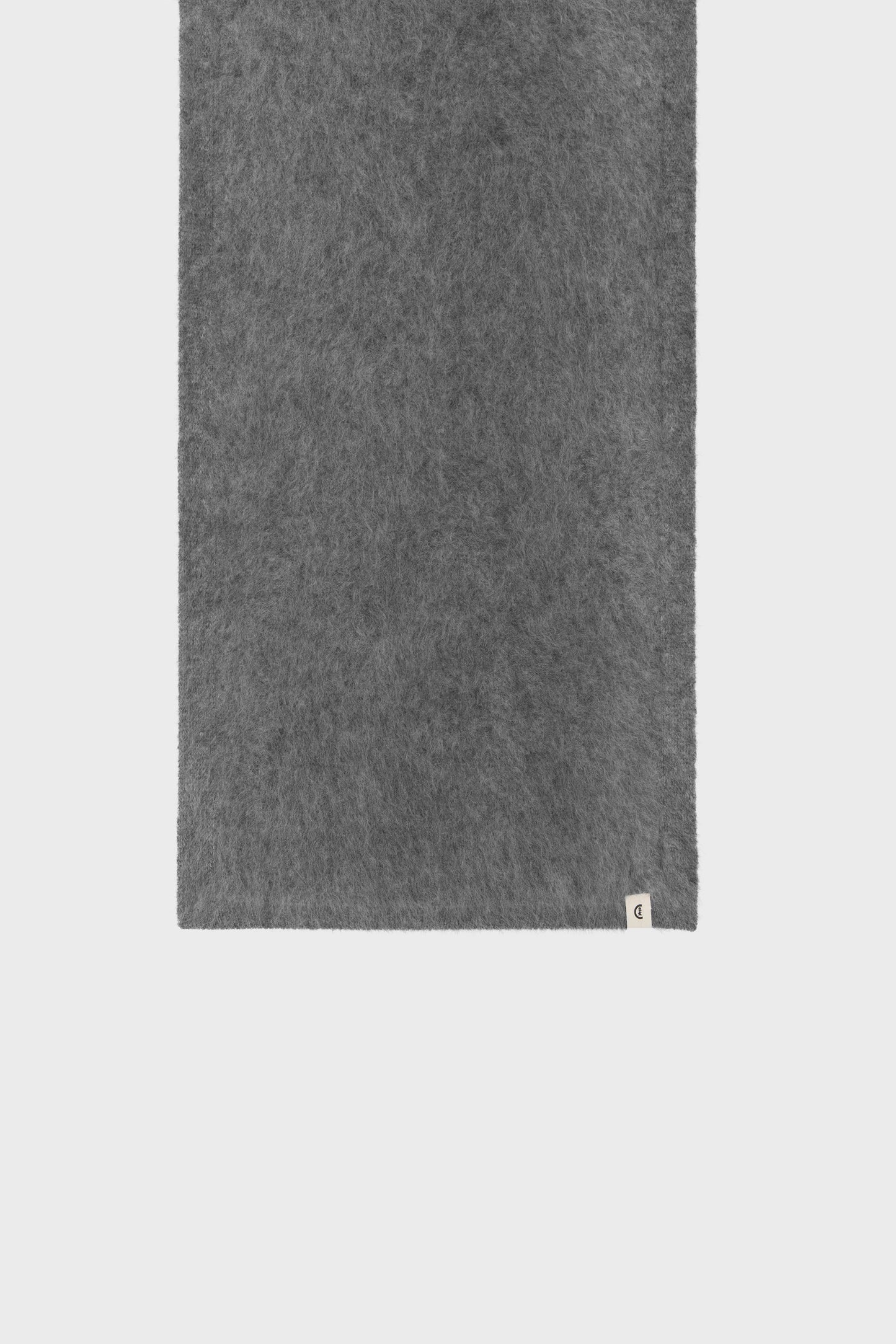 Close-up of the fabric revealing the soft cashmere texture and clean, lightweight weave.