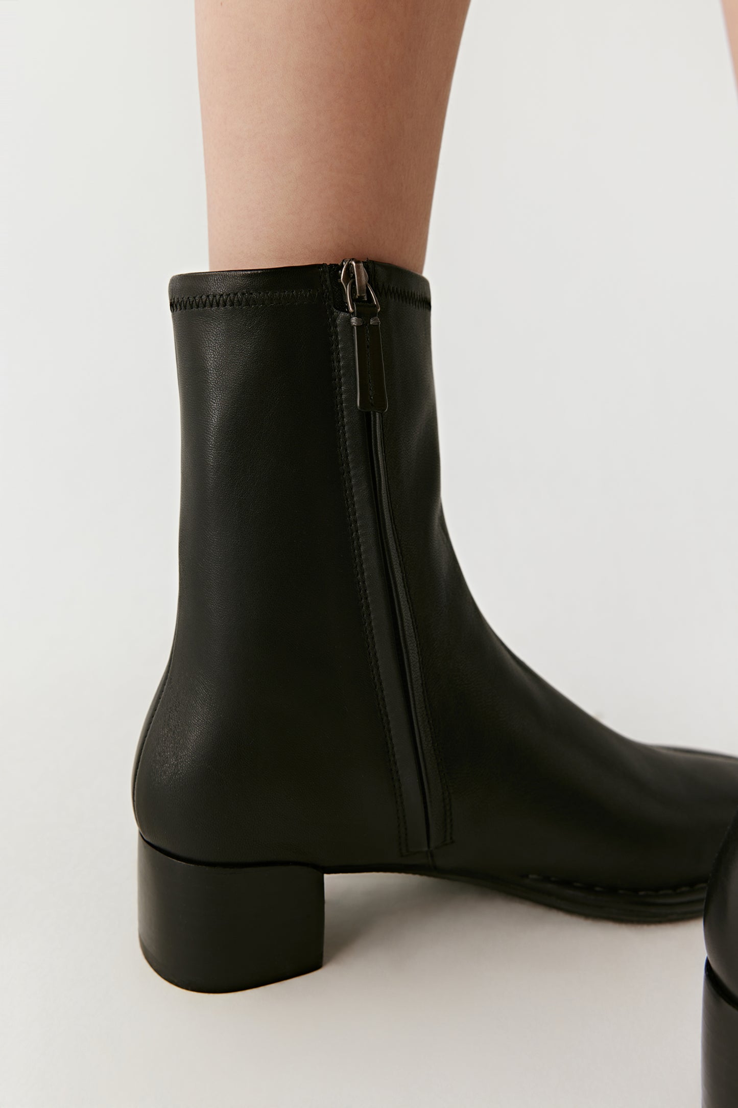 Rear three-quarter view emphasizing the boot’s natural curve and balanced proportions.