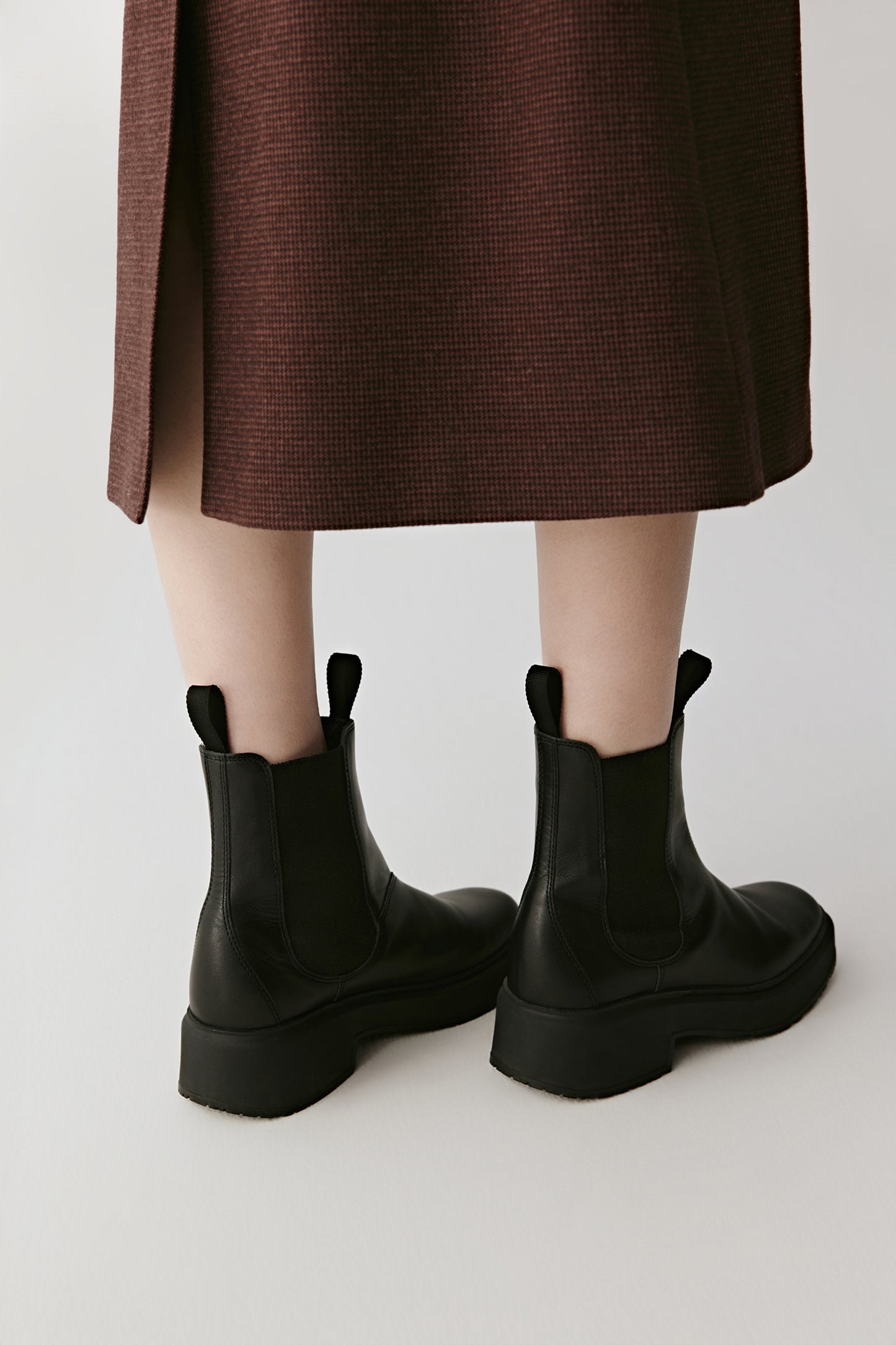 Rear three-quarter view showing the ankle fit and flexible design for movement.