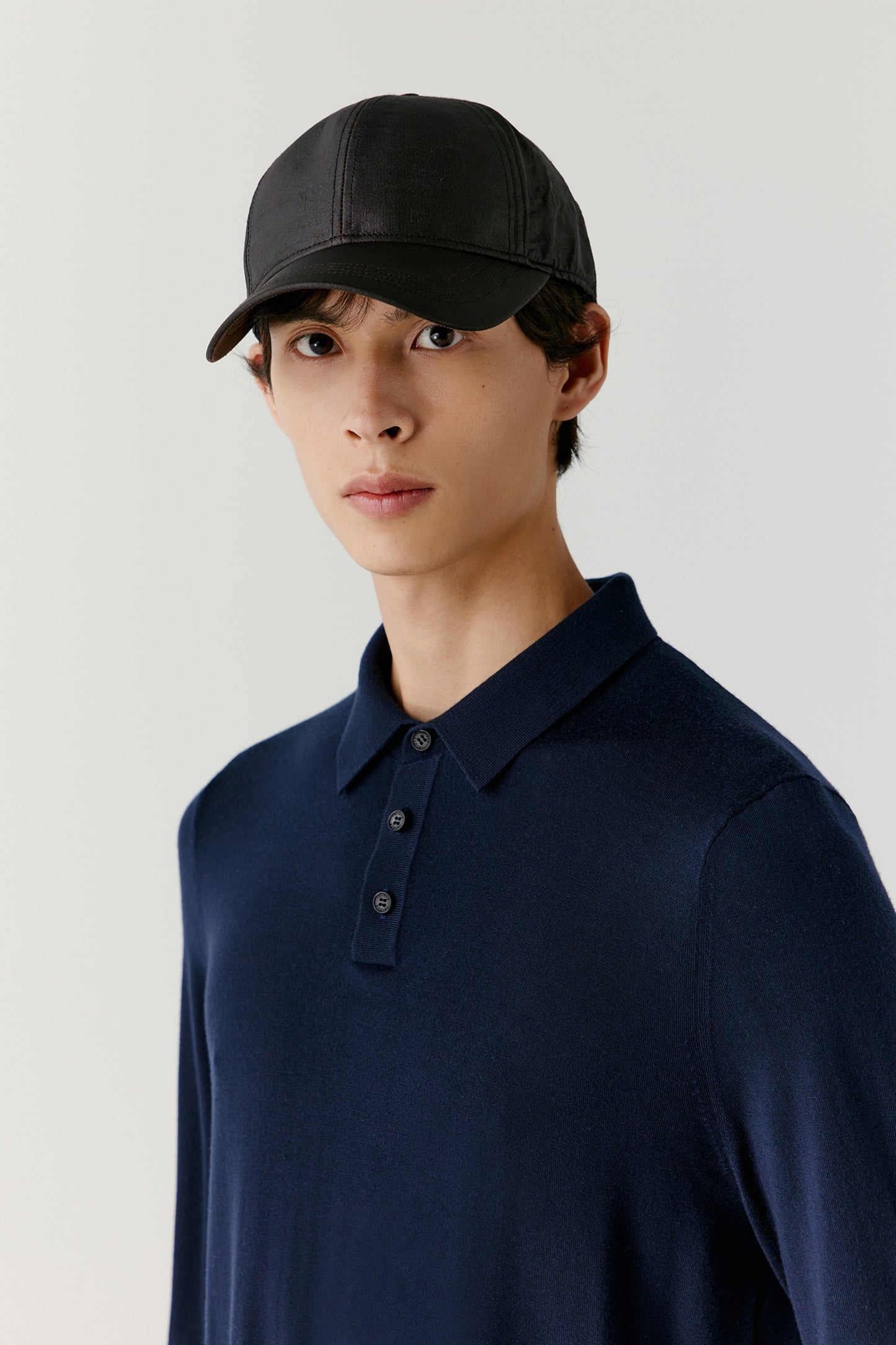 A portrait frame focuses on the face and upper torso, showing the breathable, natural weave of the wool.