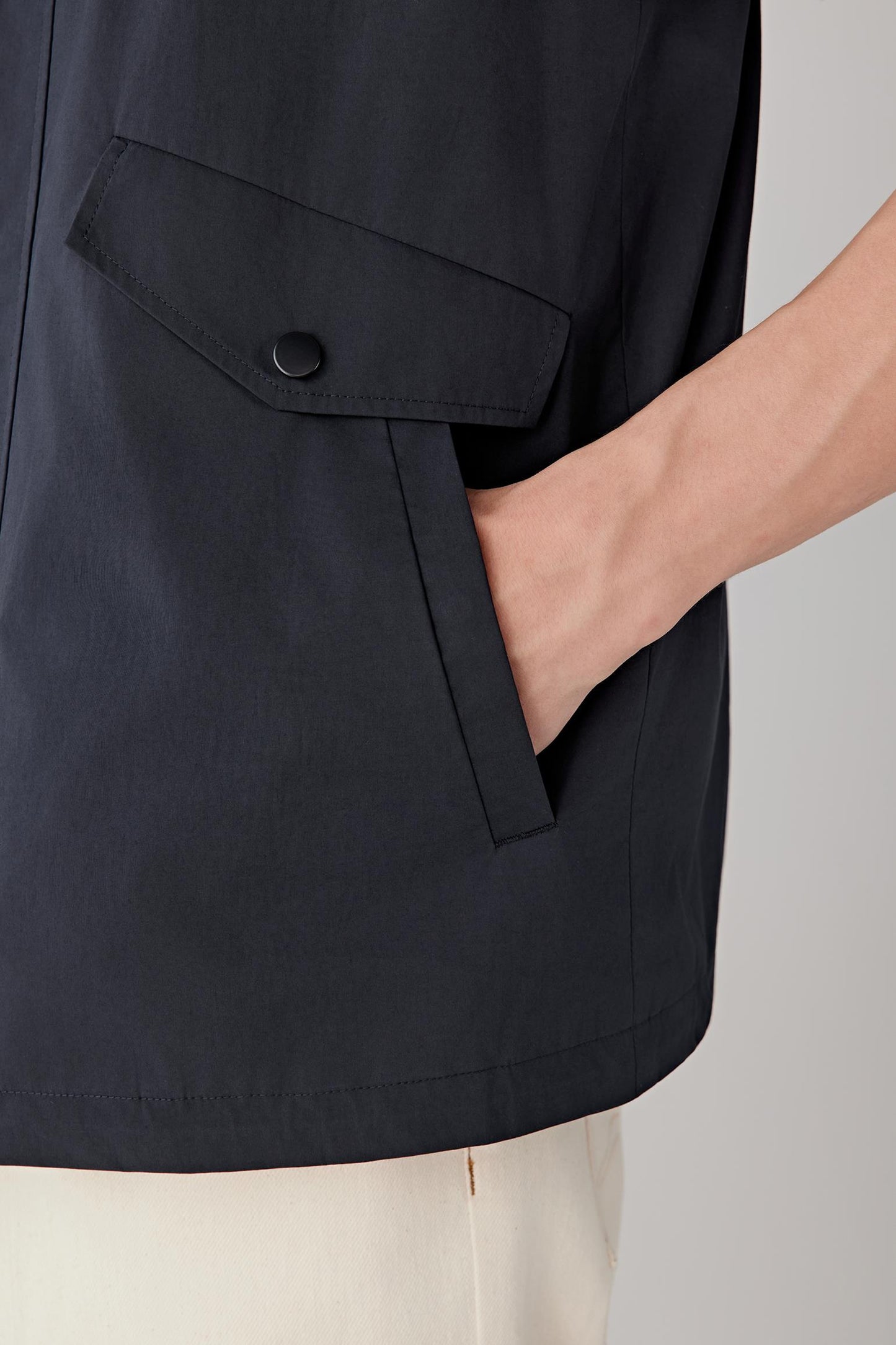 Detail view of the pocket and fabric, highlighting the smooth poplin weave.