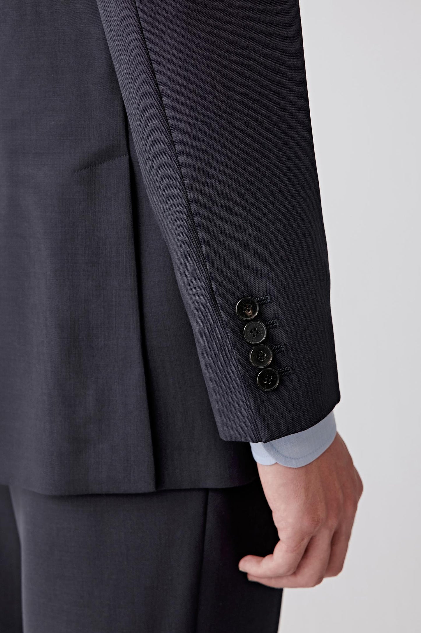 Close-up of the front lower panel and pocket, showing the discreet pocket construction, smooth surface and minimal finishing details.