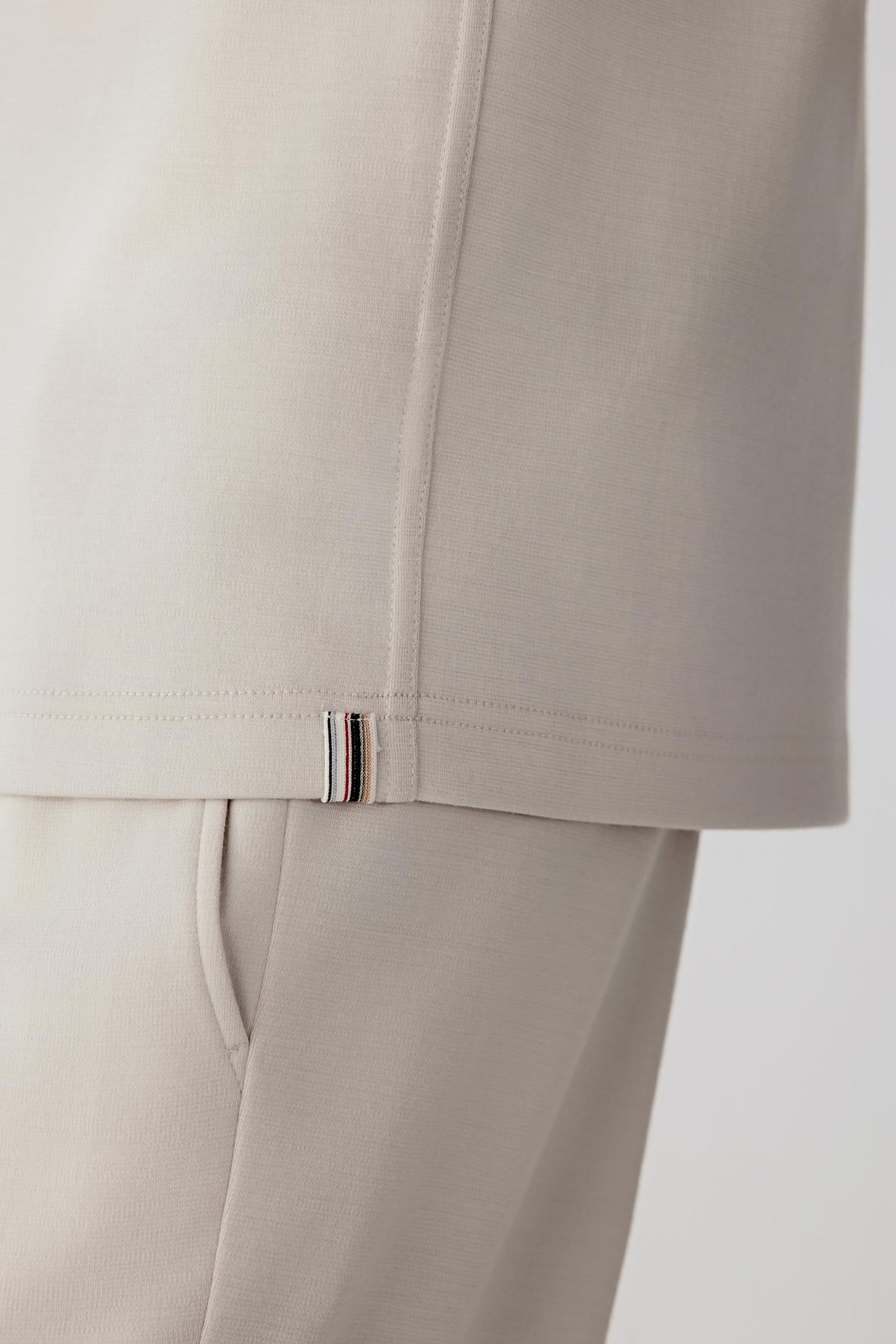 Fabric close-up revealing the dense, compact knit characteristic of Ponte de Roma wool.