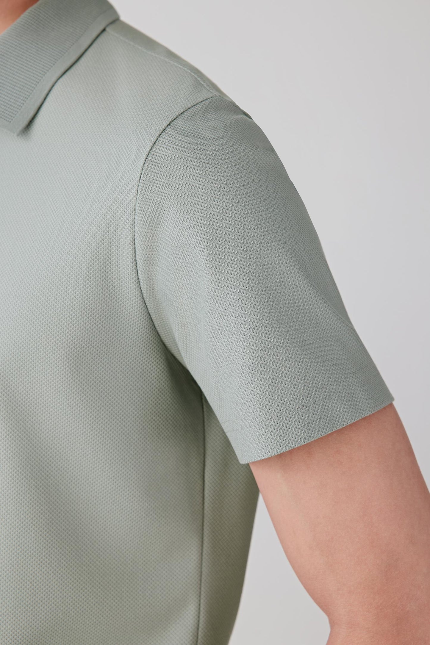 Detail of the sleeve highlighting the clean edge finishing and soft, breathable jersey construction.