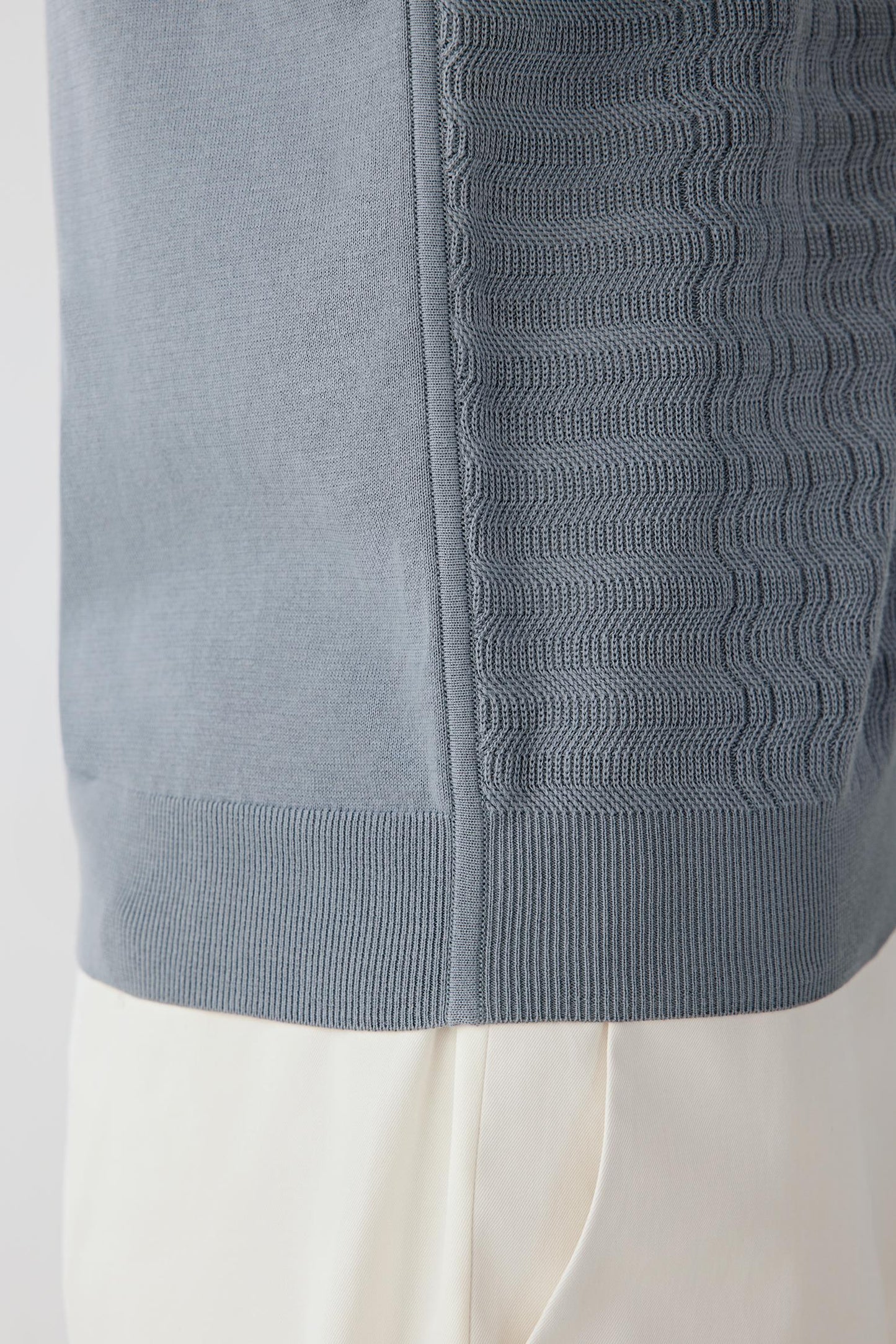 Close-up of the knit structure showing the regular stitch definition, soft matte finish and breathable texture characteristic of fine-spun cotton.