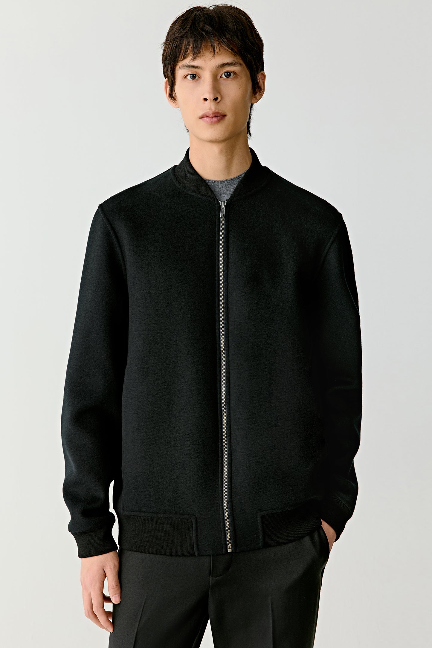 Portrait close-up revealing the fine wool texture and subtle collar structure.