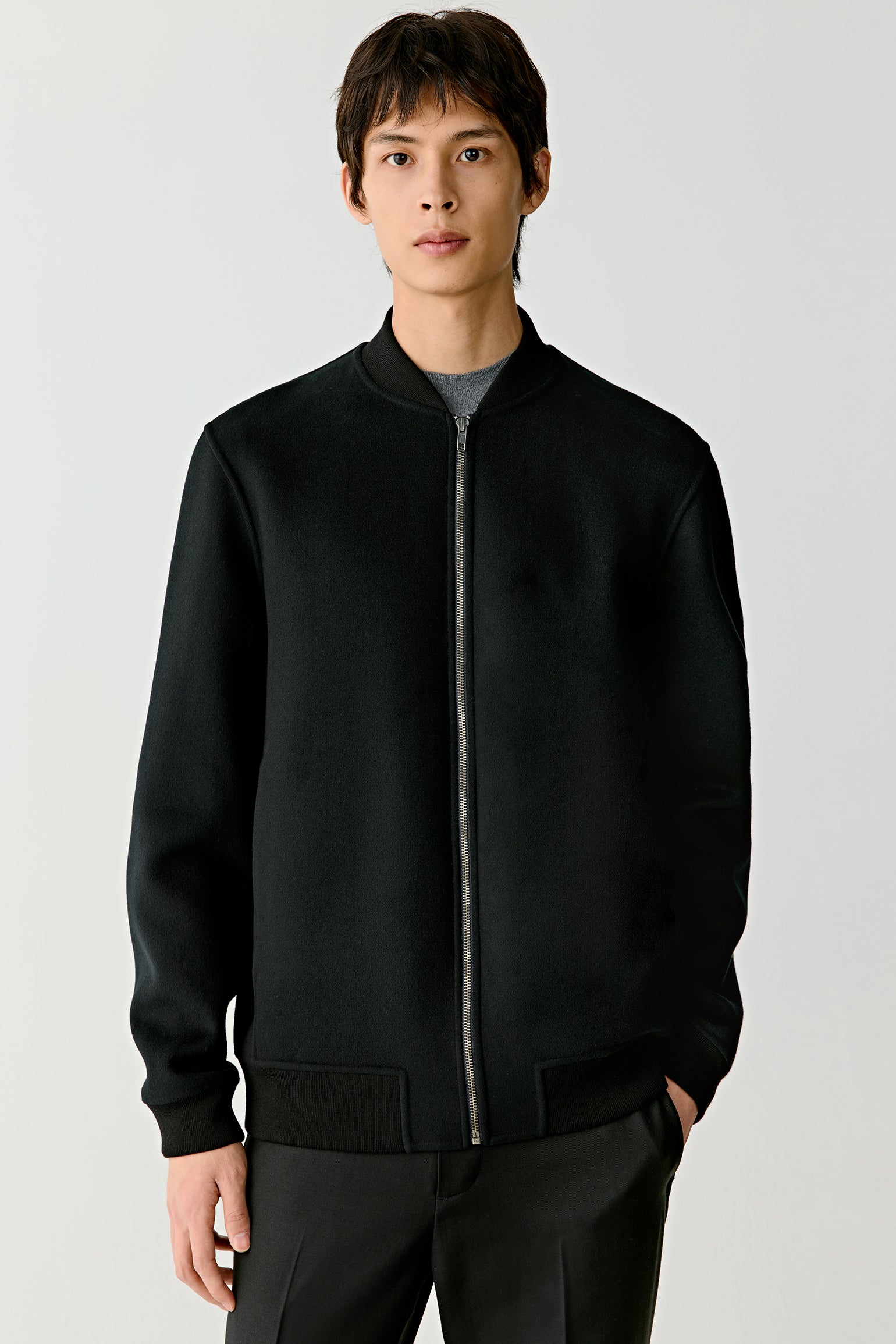 Portrait close-up revealing the fine wool texture and subtle collar structure.