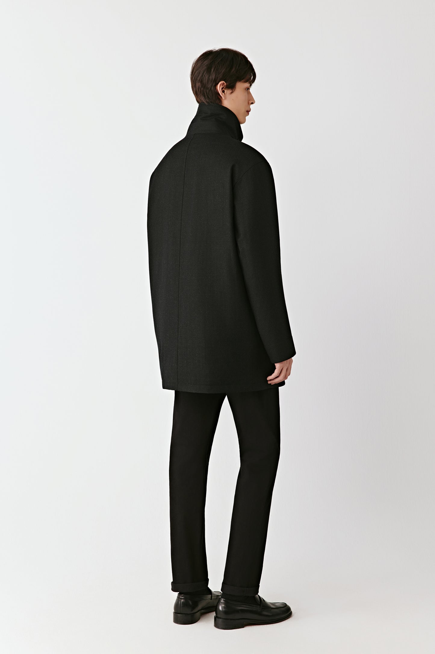 Rear three-quarter view displaying the straight back and lightly padded structure.