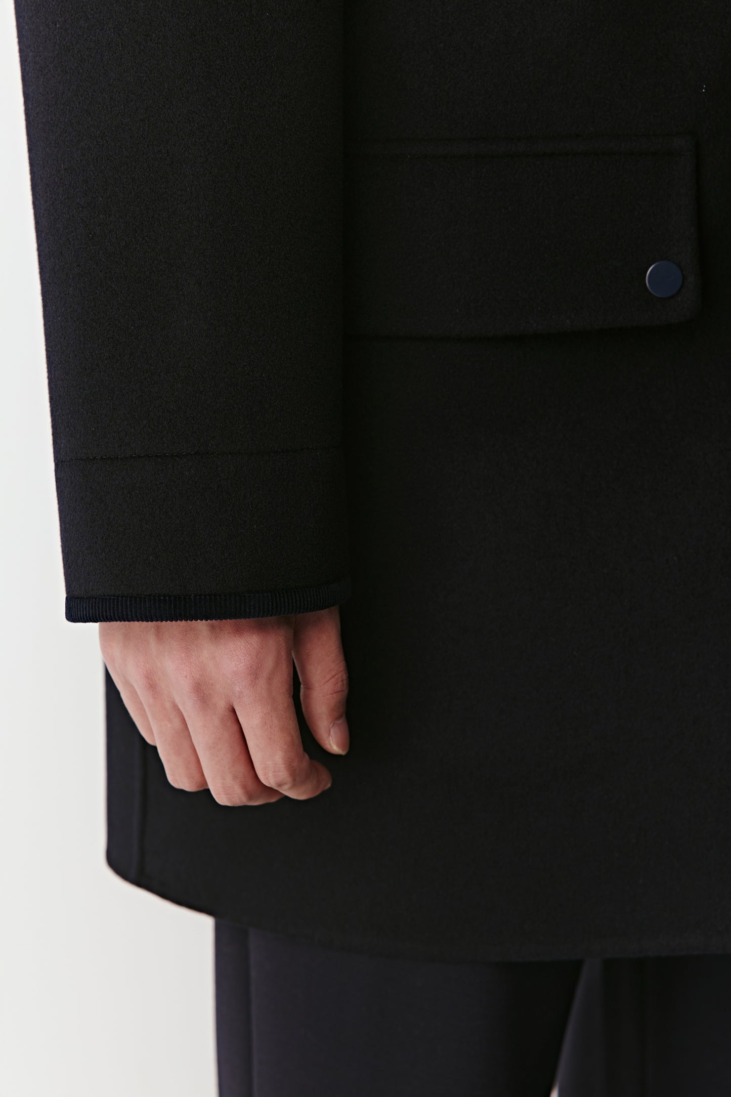 Black coat with a pocket on a white background