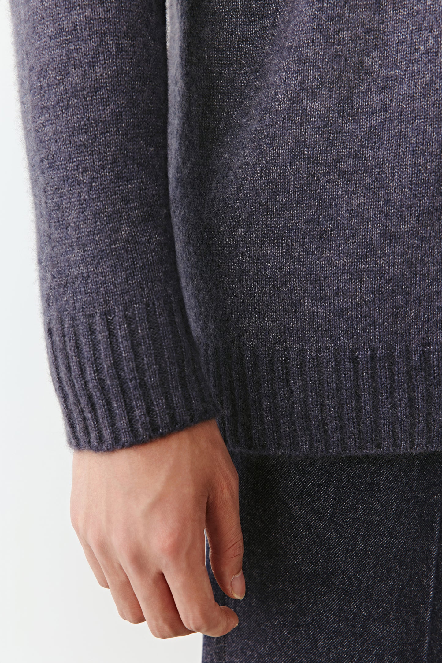 Close-up of the hem and sleeve ribbing revealing the craftsmanship and fine texture.