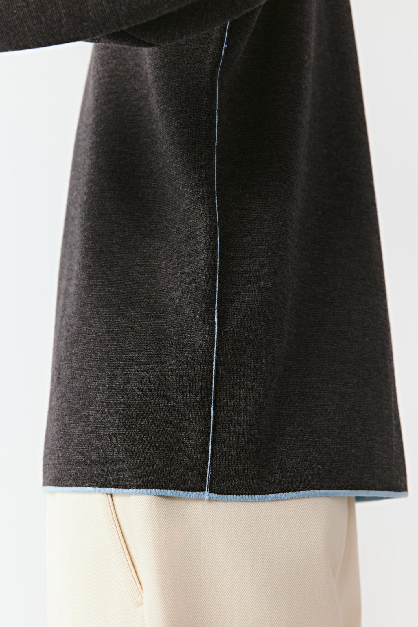 Dark gray coat with a light blue lining on a white background