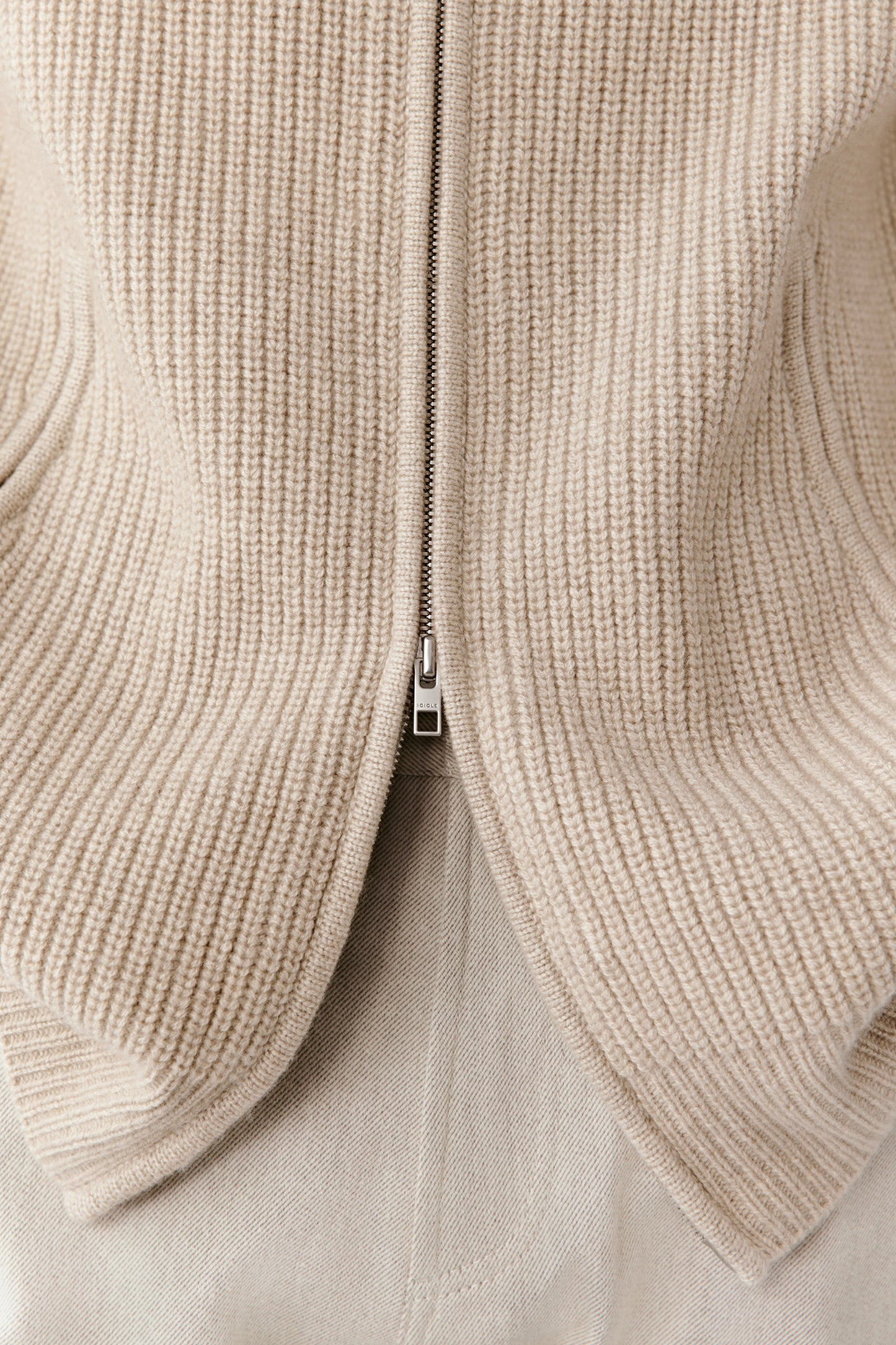 Detail shot of the zip and ribbed edges, showing the softness and craftsmanship of the undyed cashmere.