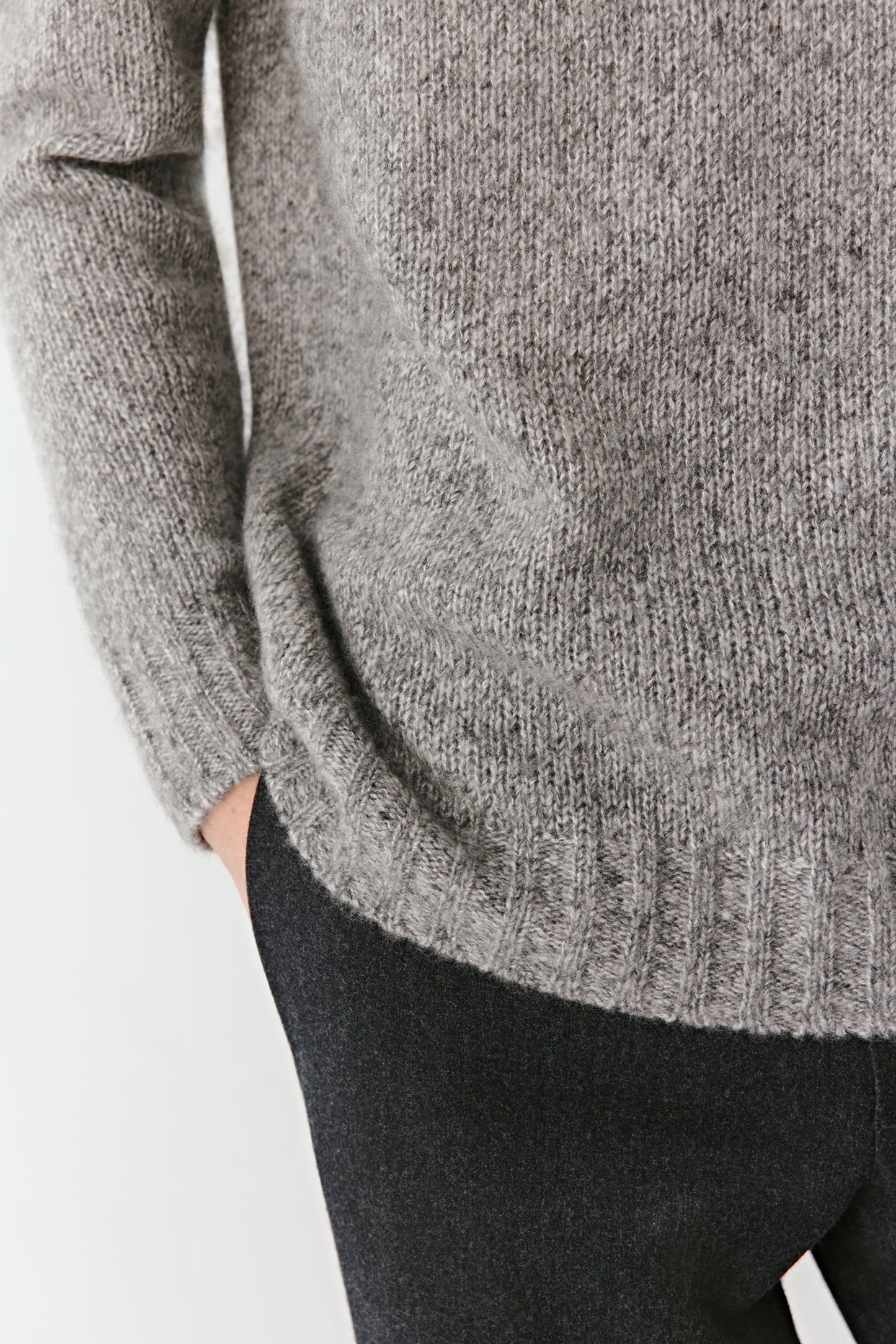 Close-up of the mock neck and ribbed collar, showing the refined craftsmanship and light, breathable knit.