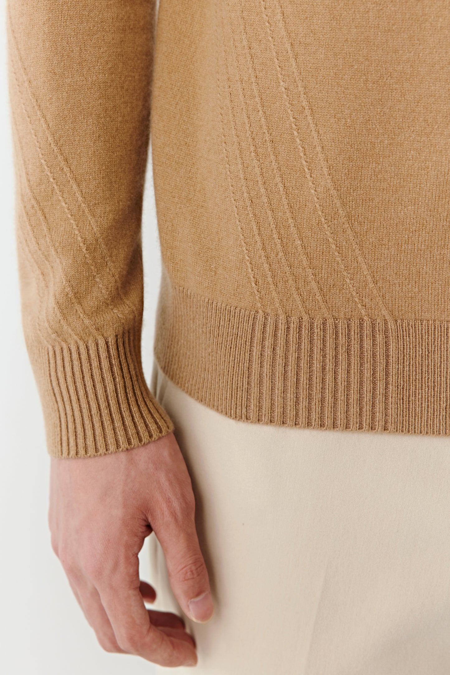 Detail shot of the ribbed cuff and cashmere texture, showcasing the softness and craftsmanship.
