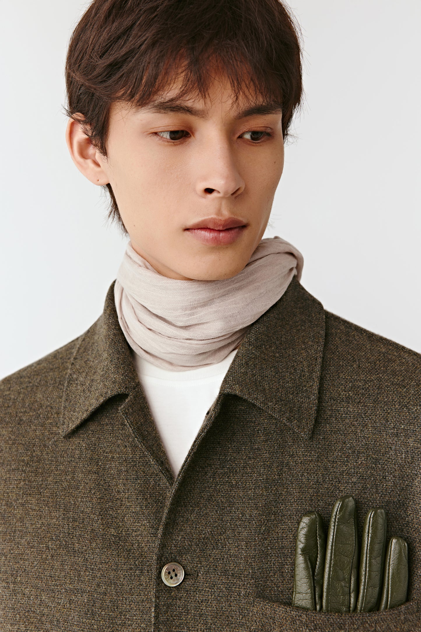 Close-up portrait of the shirt collar and pocket, showing the fine wool-cashmere fabric and matte buttons.