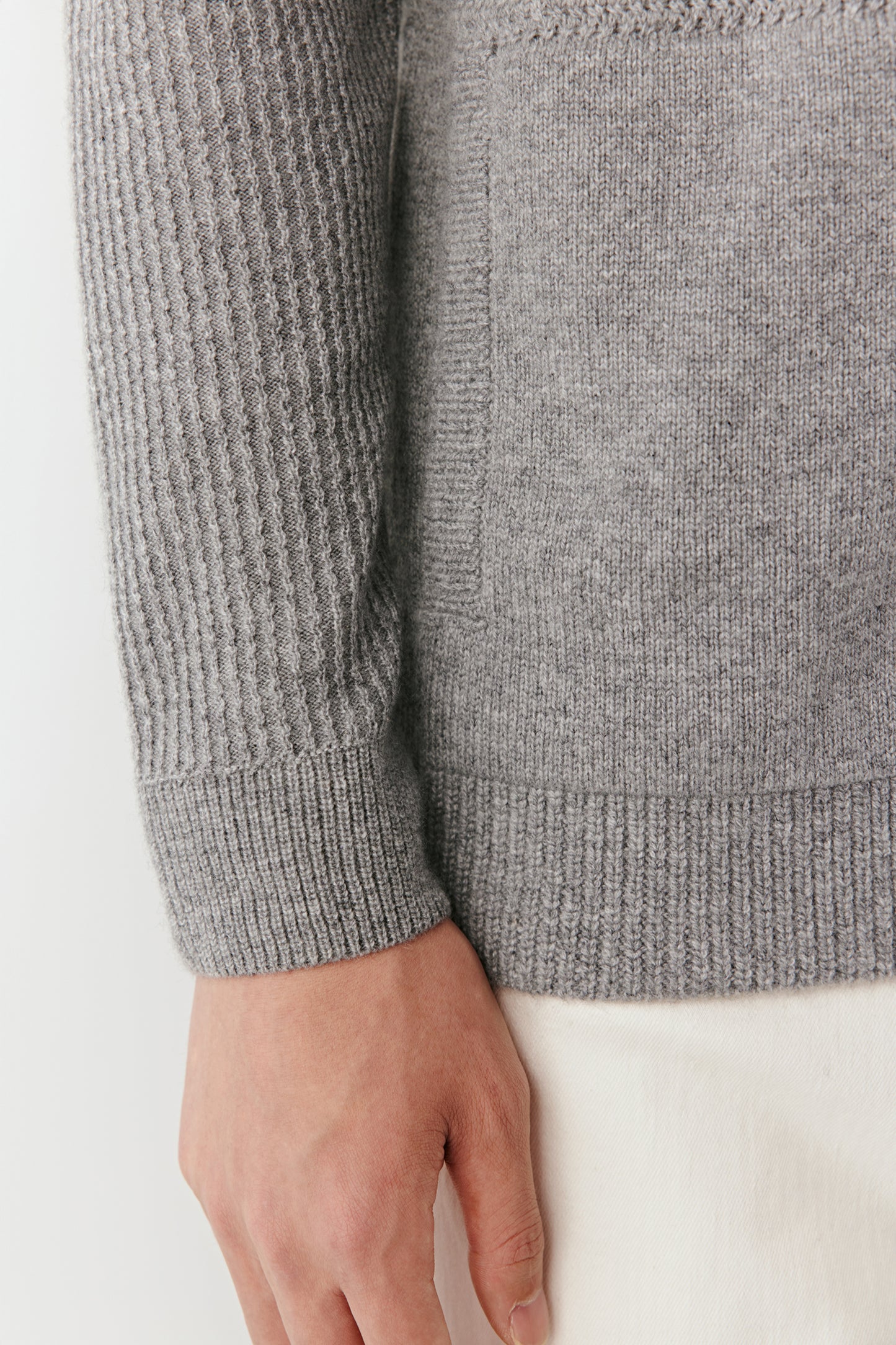 Gray knitted sweater with a white background