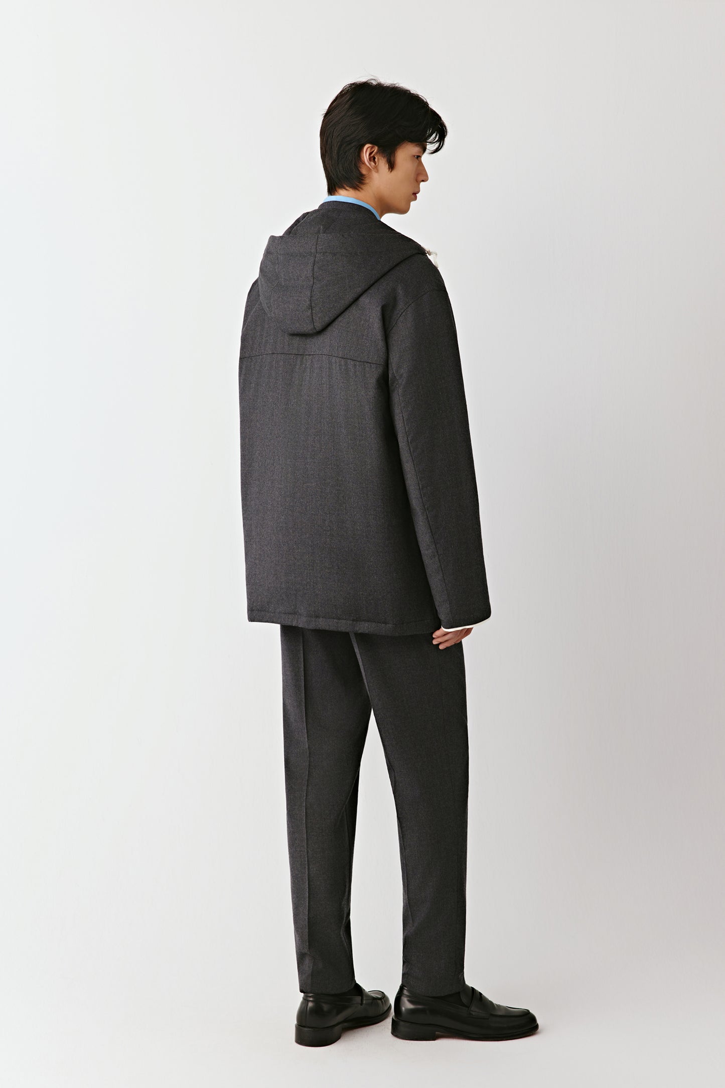 Rear view showing the fitted shape and minimalist cut.