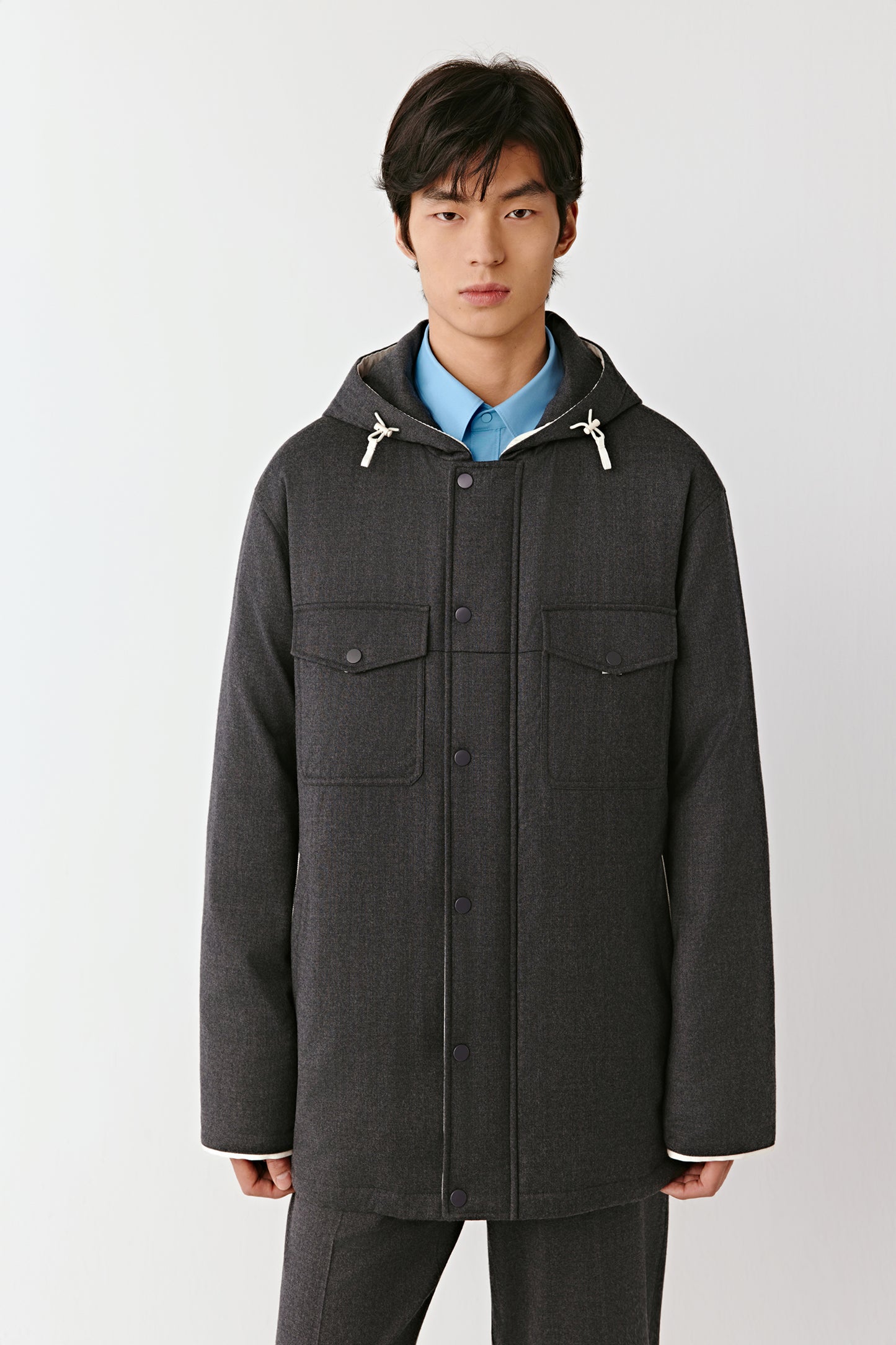 Front view showing the jacket’s straight fit and subtle padding.