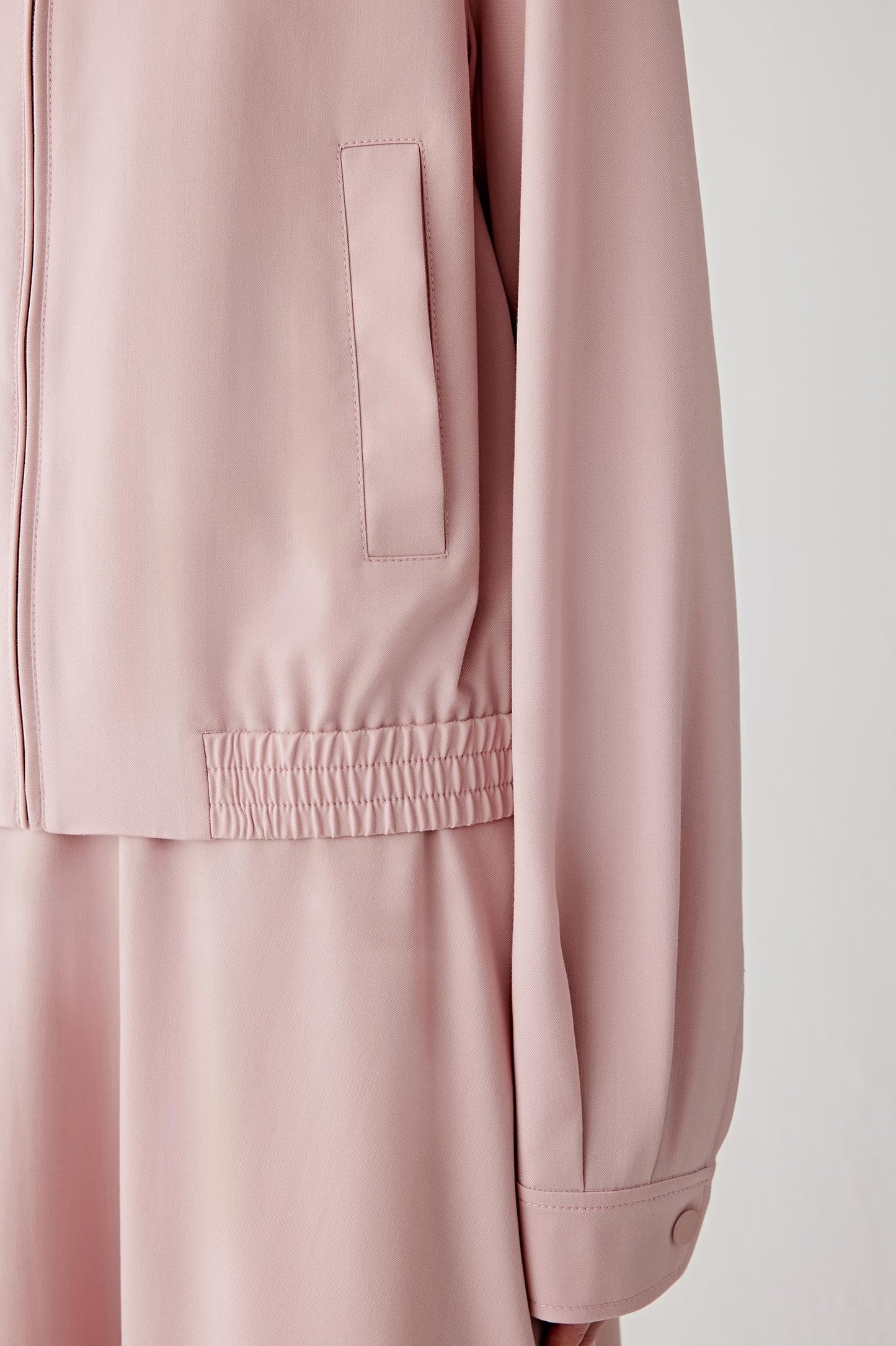 Close-up of the sleeve and cuff, showing smooth seams and a clean, minimal finish.