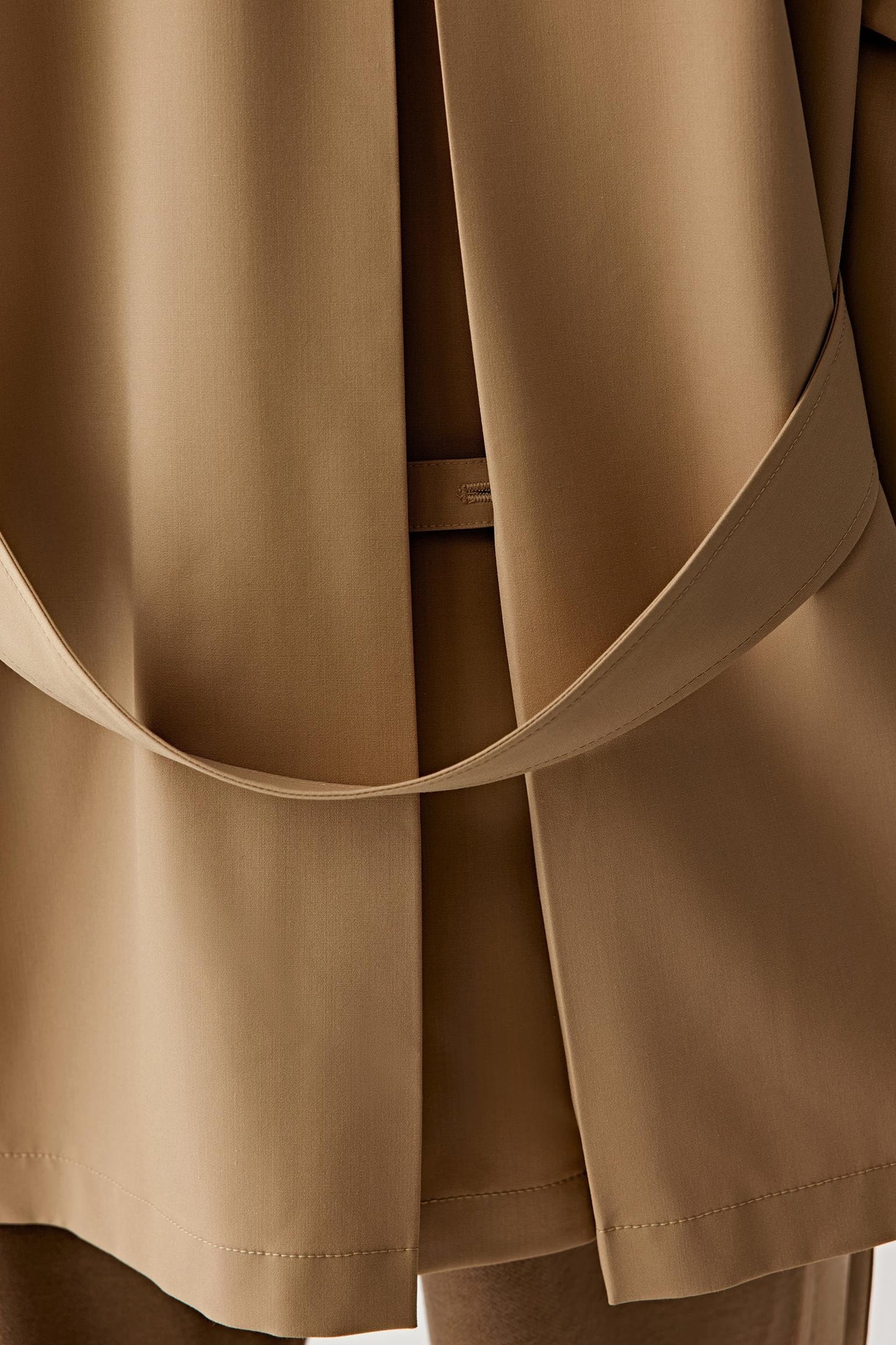 Close-up of the belt detail and wool texture.