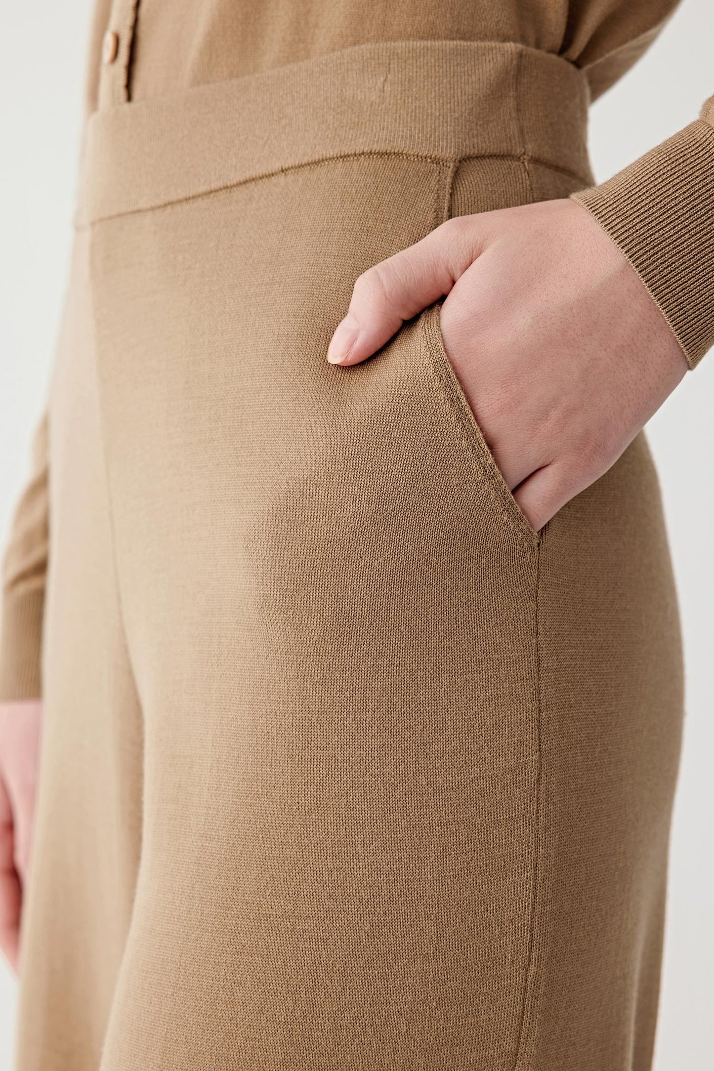 Close-up of the side pocket and fabric texture, revealing smooth wool finish.