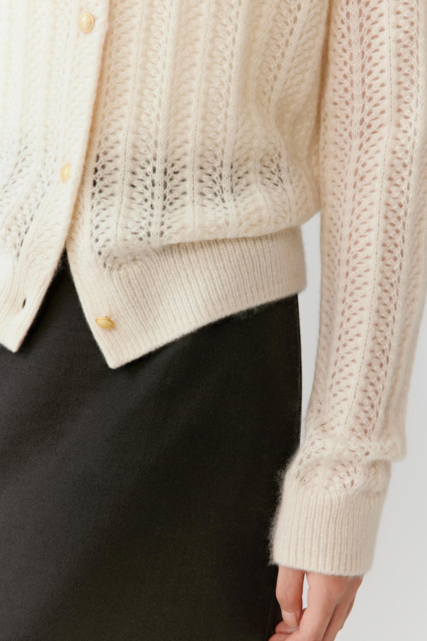 Close-up of the sleeve and cuff, showing refined rib finishing and soft fabric hand feel.