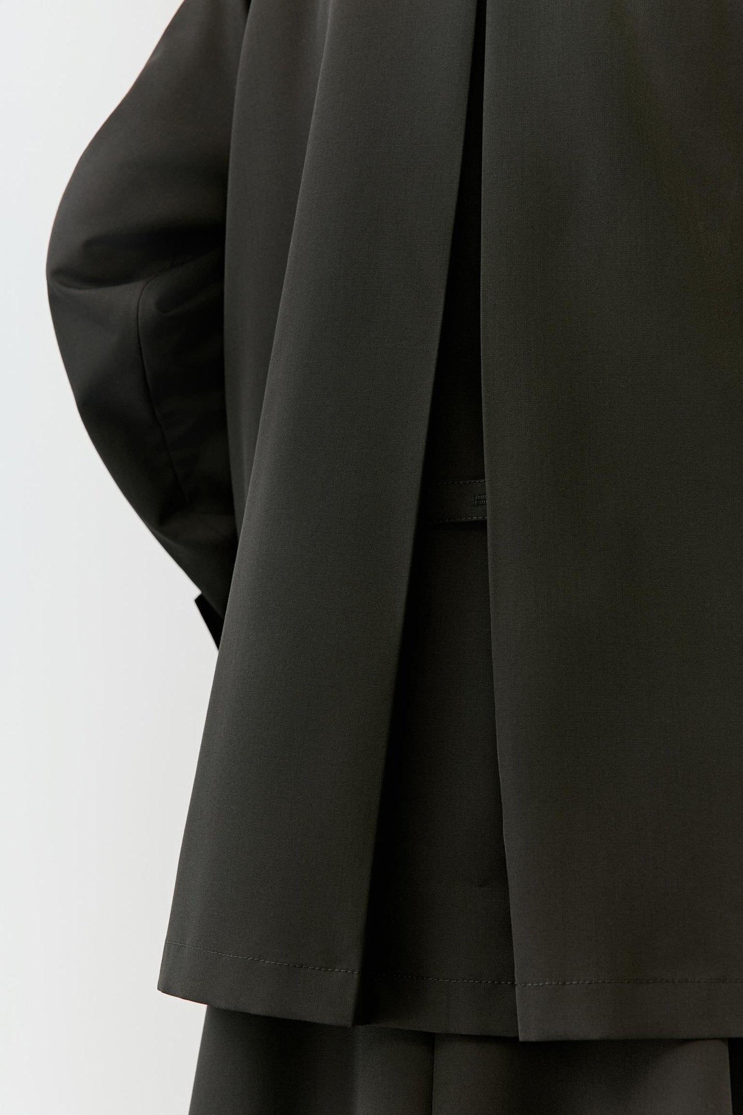 Close-up of the sleeve and cuff, highlighting clean finishing and fabric density.