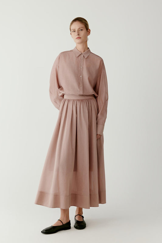 Full-length front view styled with a matching skirt, highlighting the loose silhouette, lightweight fabric and clean vertical fall