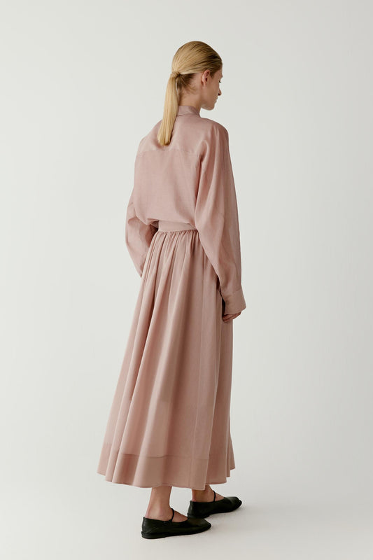 Full-length back view highlighting the airy volume, soft drape and even distribution of the pleats around the skirt