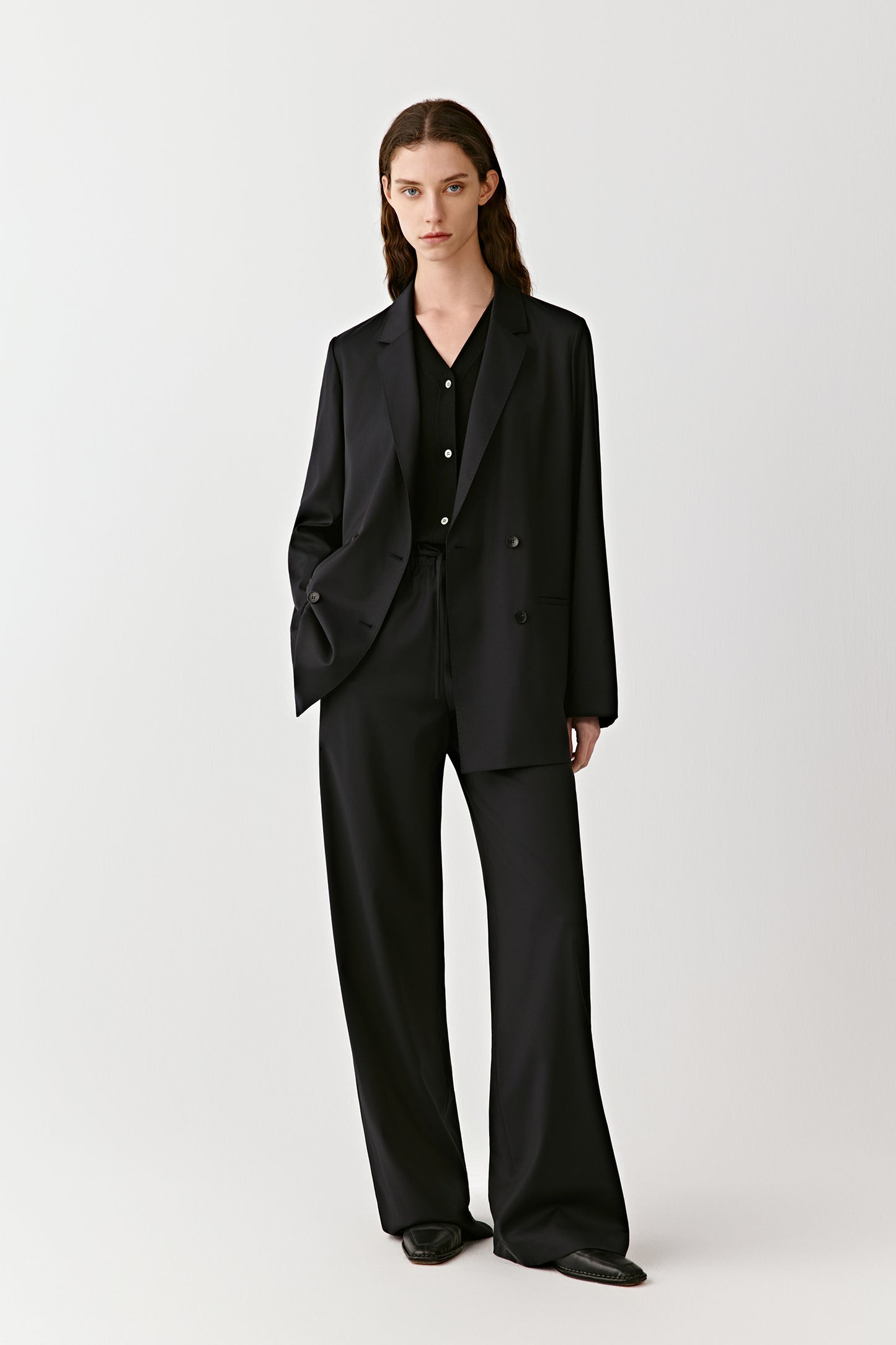 The side angle captures the straight silhouette and smooth fall of the fabric.