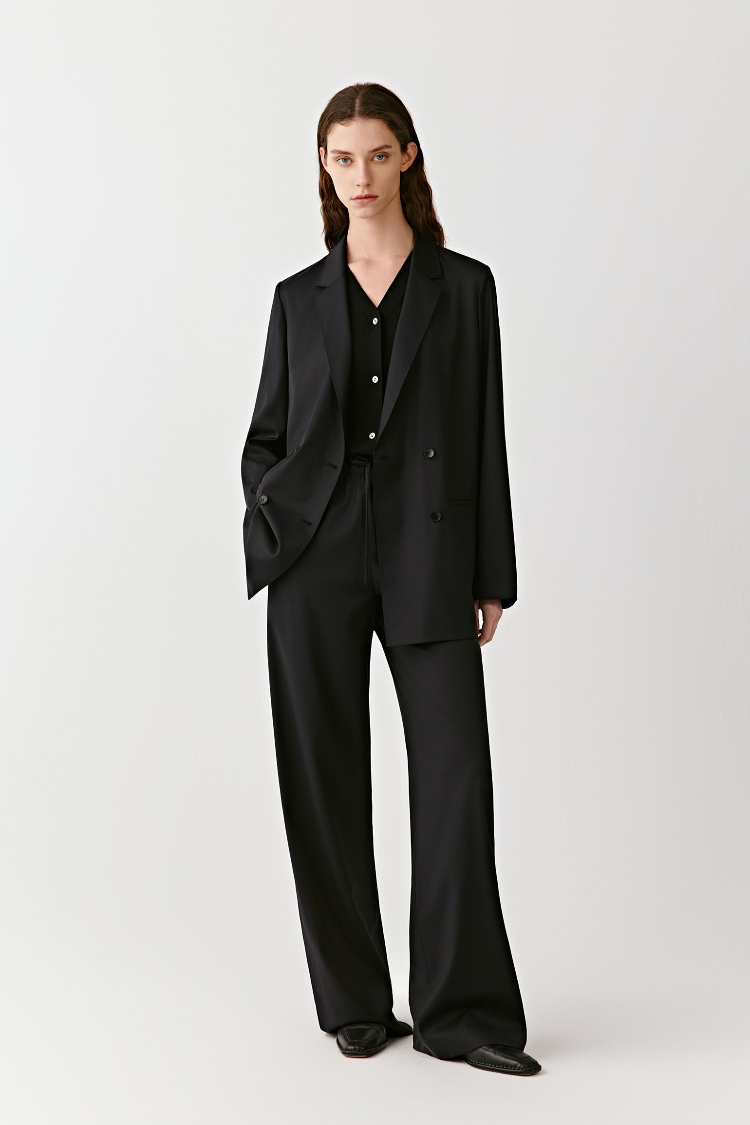 The side angle captures the straight silhouette and smooth fall of the fabric.