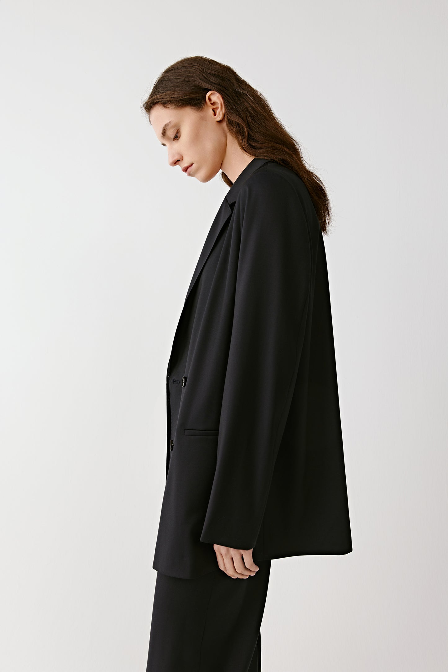 A side view highlighting the lines of the blazer.