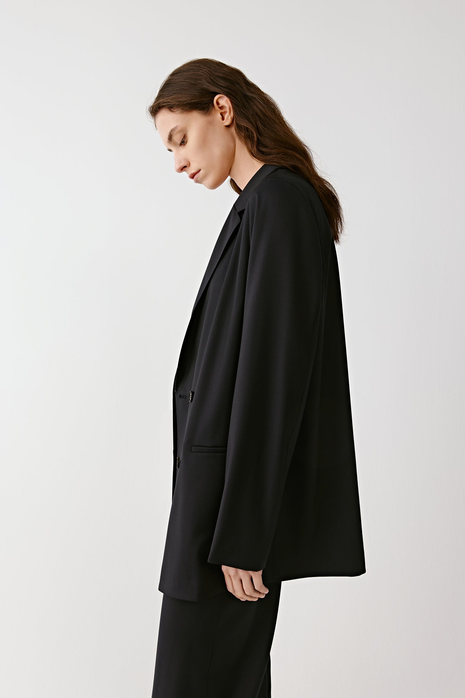 A side view highlighting the lines of the blazer.