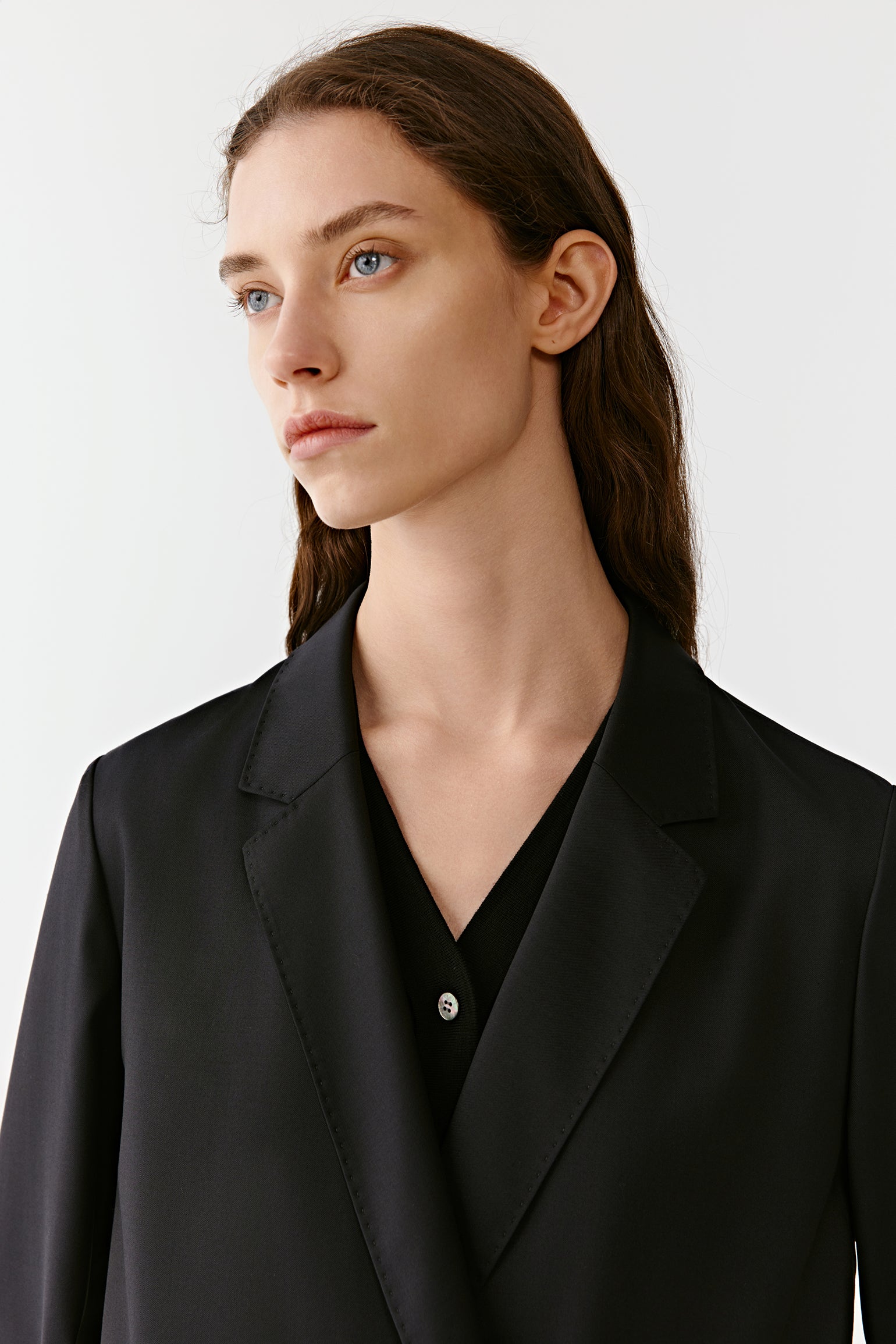 A portrait frame emphasises the face and upper torso, highlighting the matte texture of the wool.