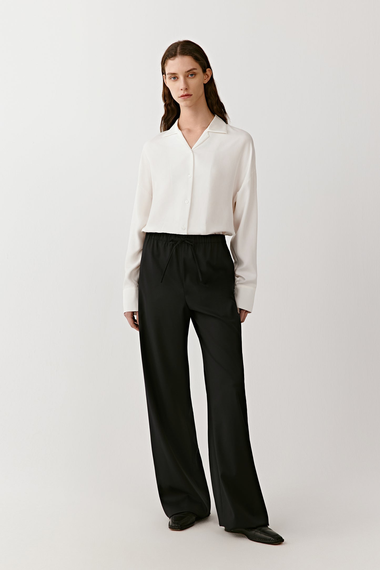 A full-length view captures the balance of fluid movement and structured cuffs.