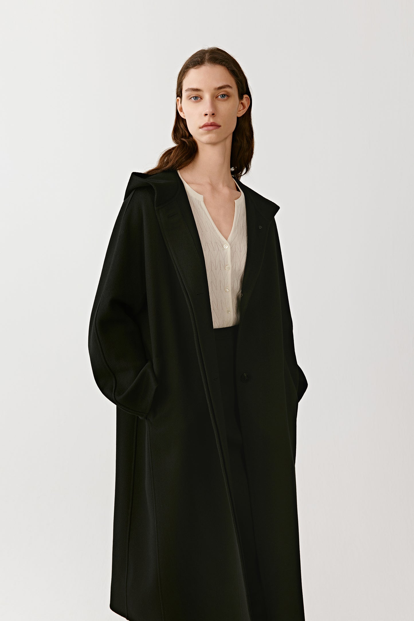 A mid-shot focuses on the hood and neckline, emphasizing the smooth cashmere texture.