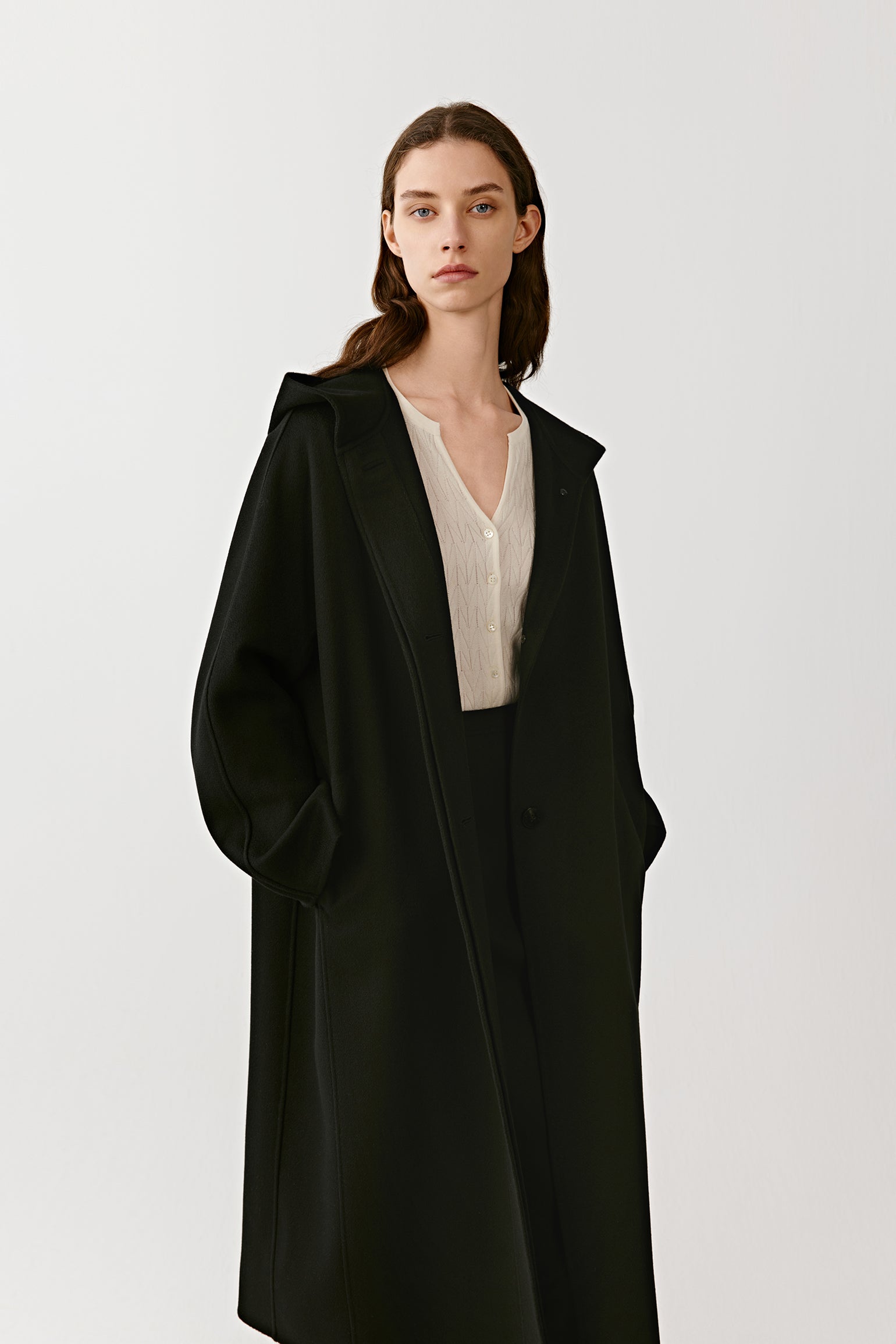 A mid-shot focuses on the hood and neckline, emphasizing the smooth cashmere texture.