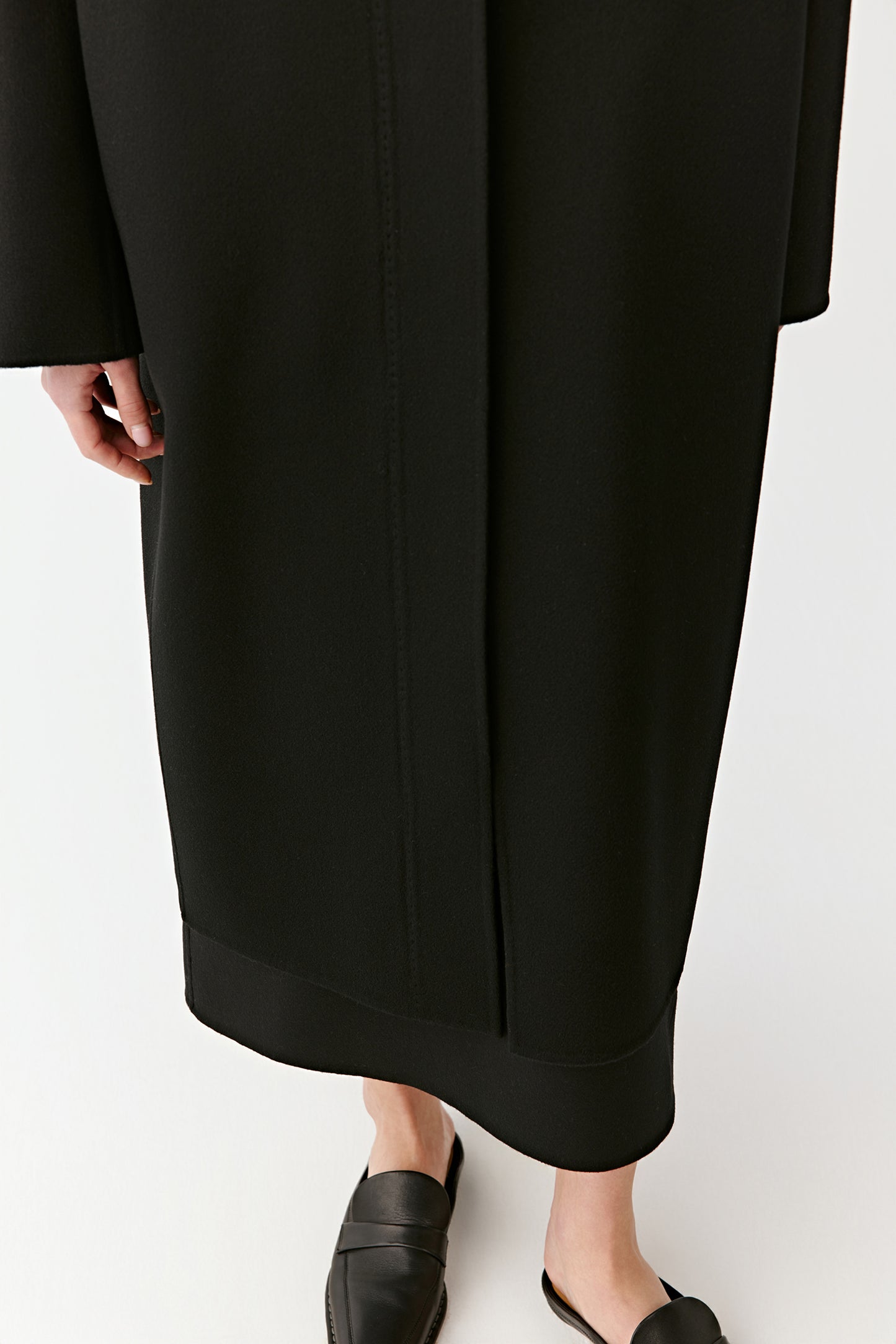 A close-up reveals the fine stitching and subtle structure of the hem.