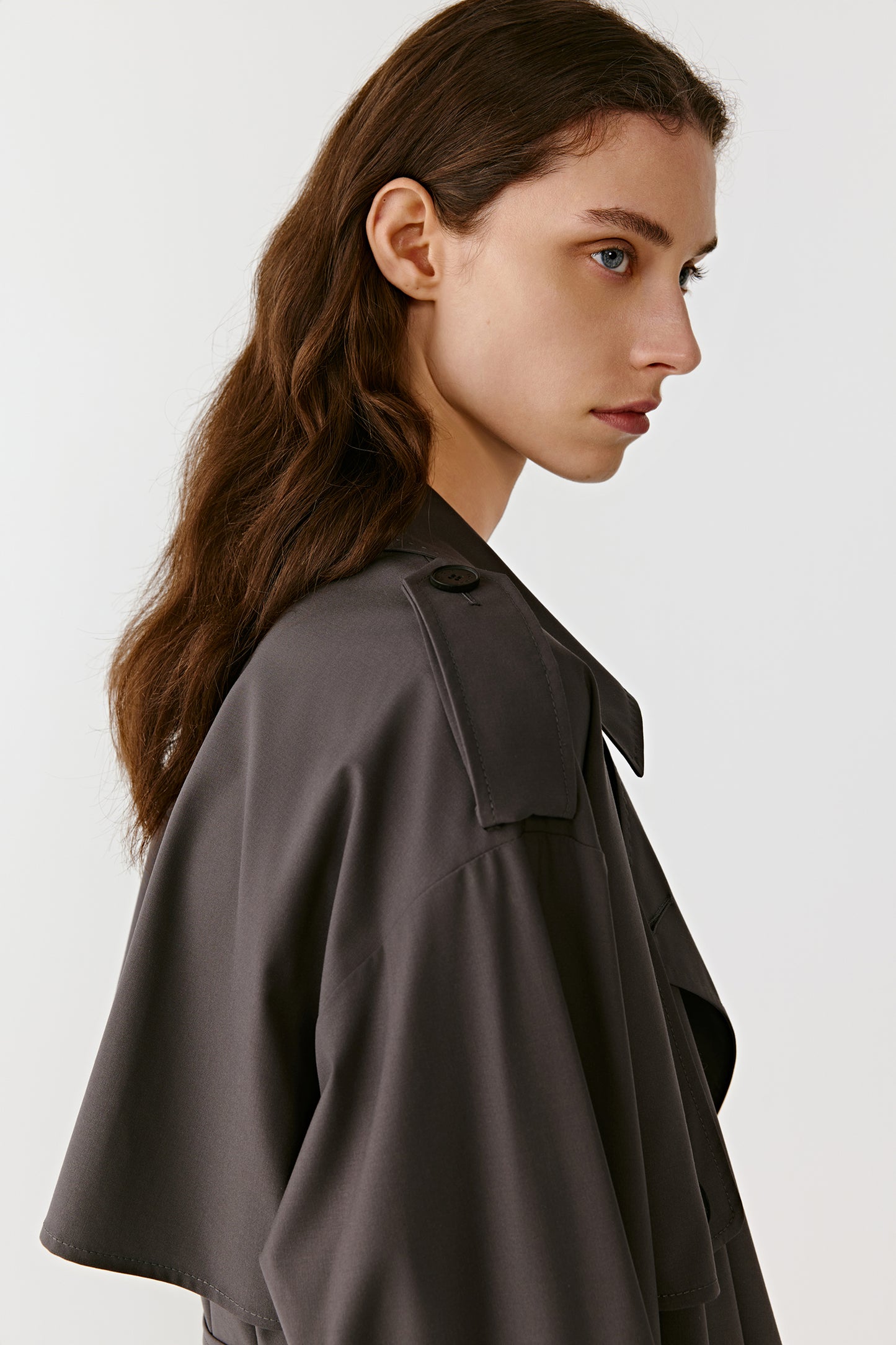 A side portrait highlights the refined texture and subtle sheen of the DEW fabric.