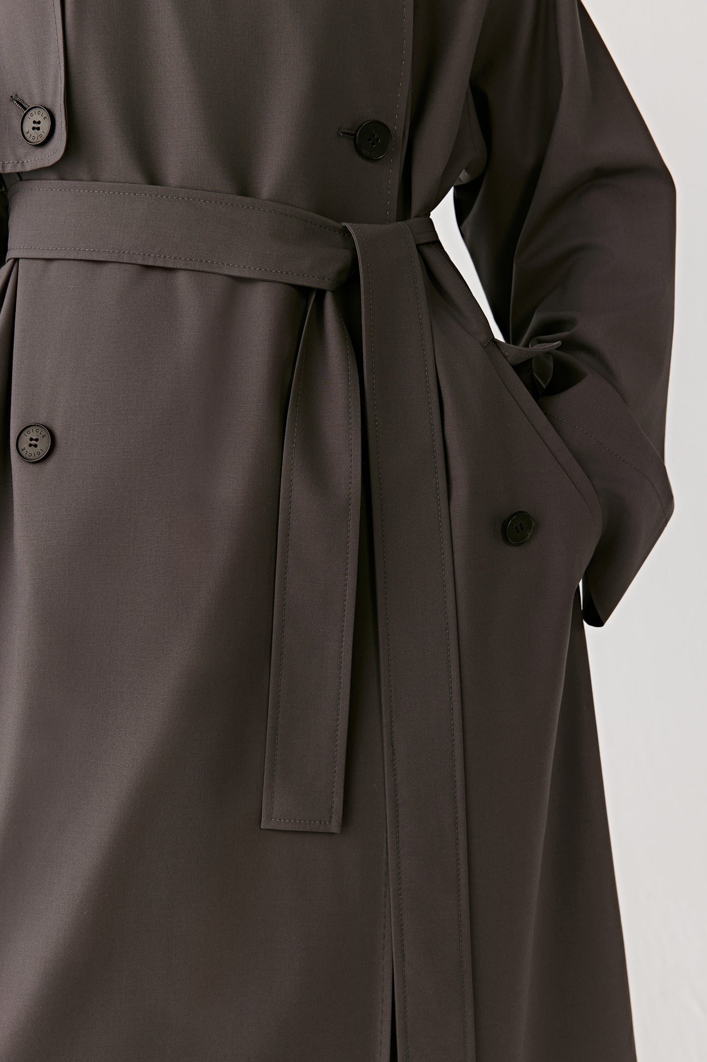 A close-up captures the buttons and stitching, showing craftsmanship through the fabric’s natural texture.