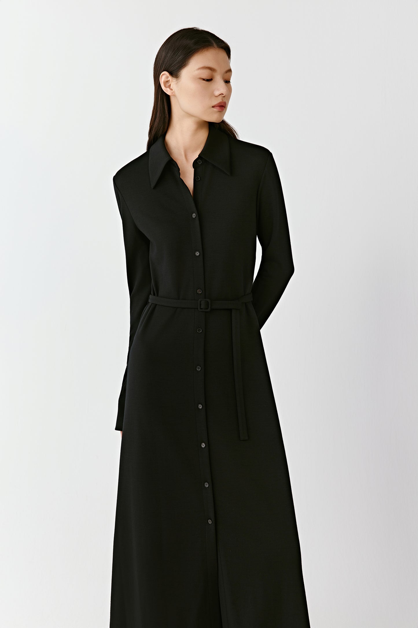 A medium shot shows the dress in motion, emphasizing its fluid drape.