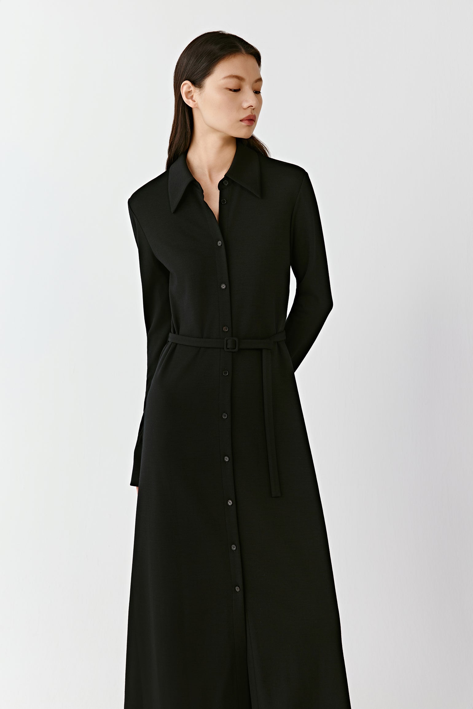 A medium shot shows the dress in motion, emphasizing its fluid drape.