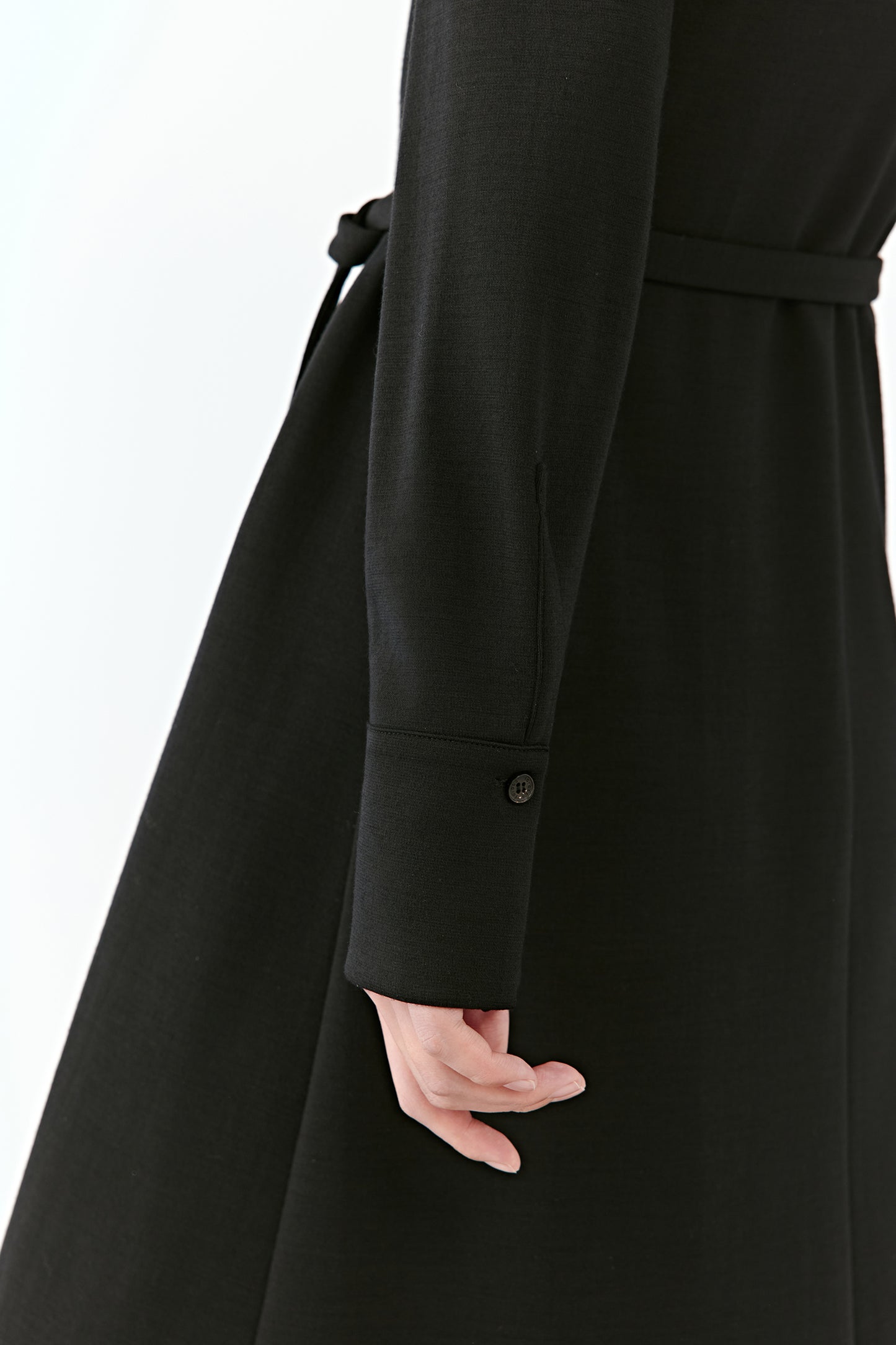 A close-up reveals the sleeve's cuff and the softness of the wool.